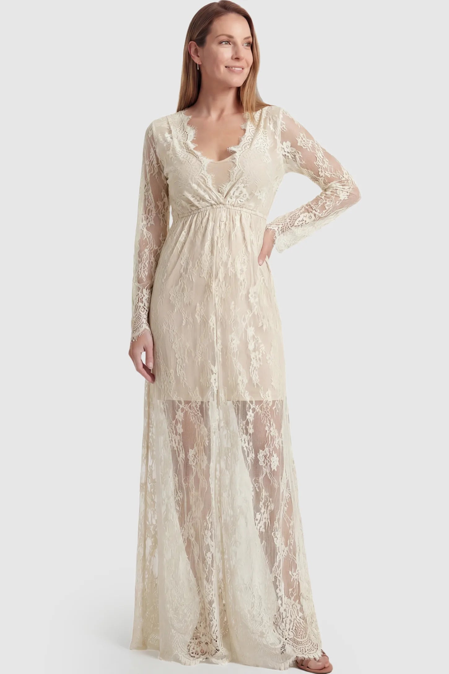 Floral Sheer Lace Long Sleeve Maternity Photoshoot Gown Floral Sheer Lace Maternity Gown in Ivory featuring scalloped v-neck and long sleeves on a postpartum model showing front.