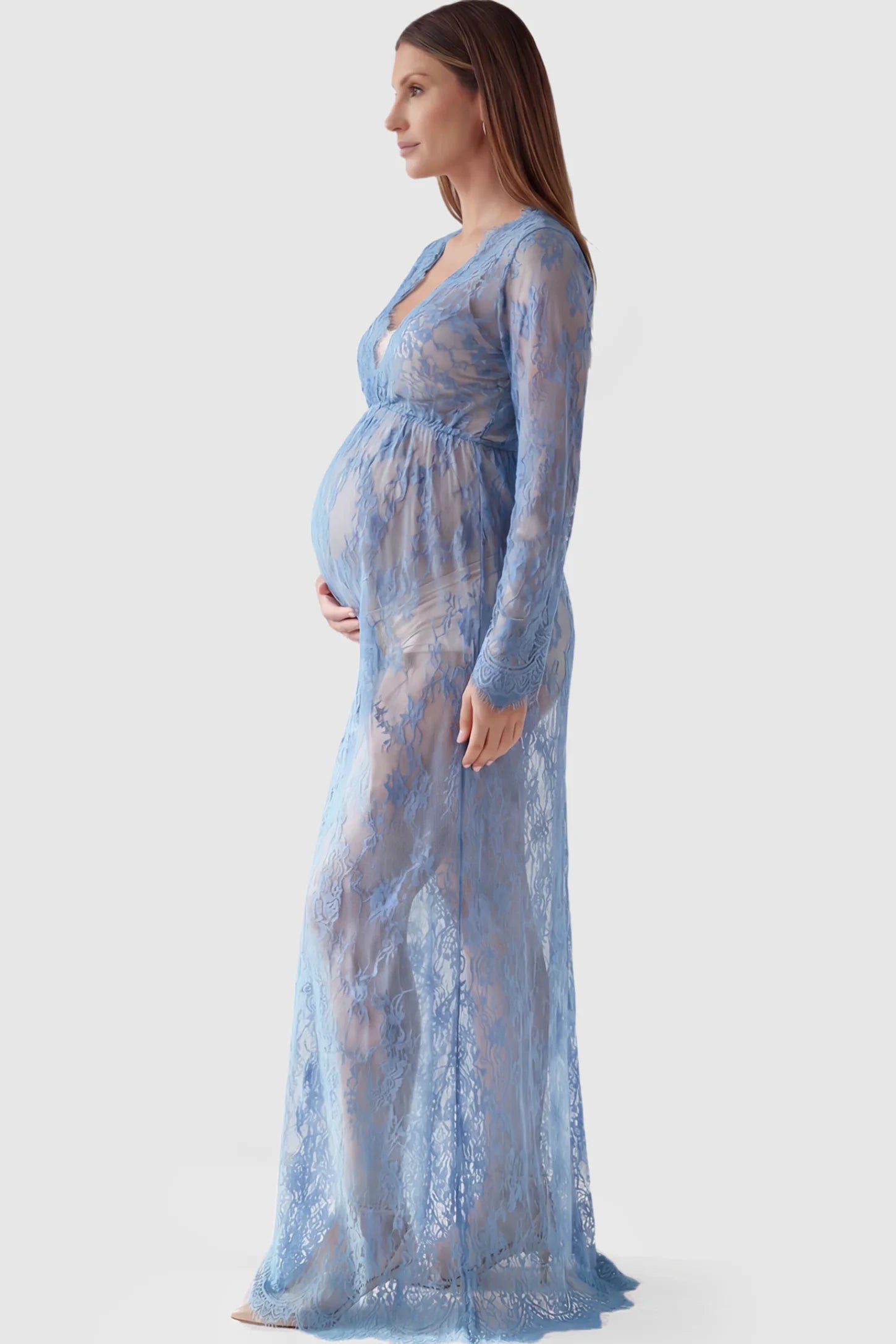 Floral Sheer Lace Long Sleeve Maternity Photoshoot Gown Floral Sheer Lace Maternity Gown in Light Blue featuring scalloped v-neck and long sleeves on a pregnant model showing side.