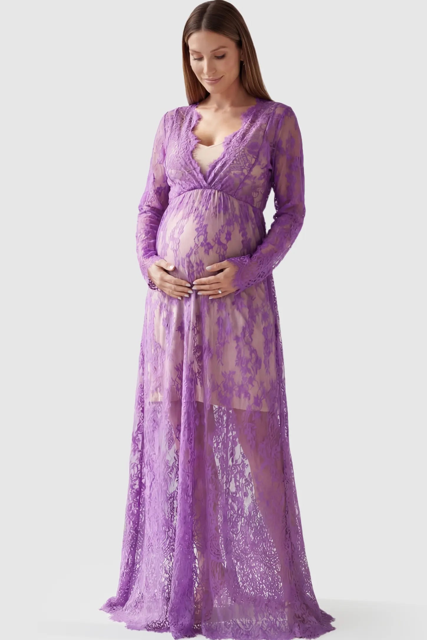 Floral Sheer Lace Long Sleeve Maternity Photoshoot Gown Floral Sheer Lace Maternity Gown in Purple featuring scalloped v-neck and long sleeves on a pregnant model showing front.