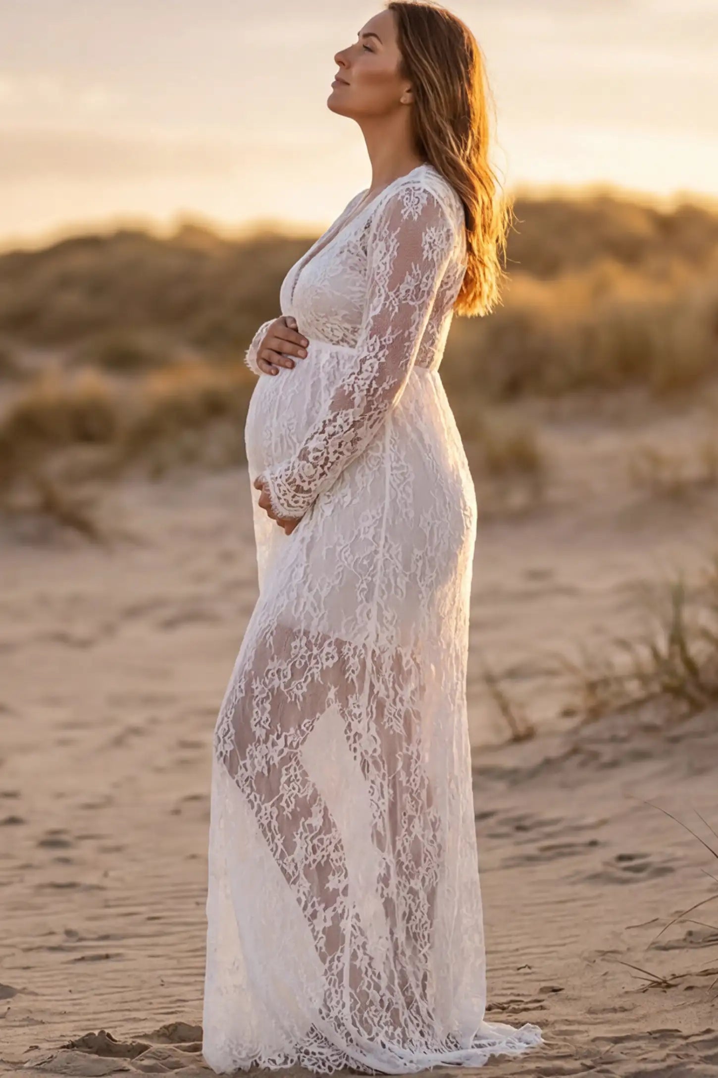 Floral Sheer Lace Long Sleeve Maternity Photoshoot Gown Floral Sheer Lace Maternity Gown in White featuring scalloped v-neck and long sleeves on a pregnant woman showing side.