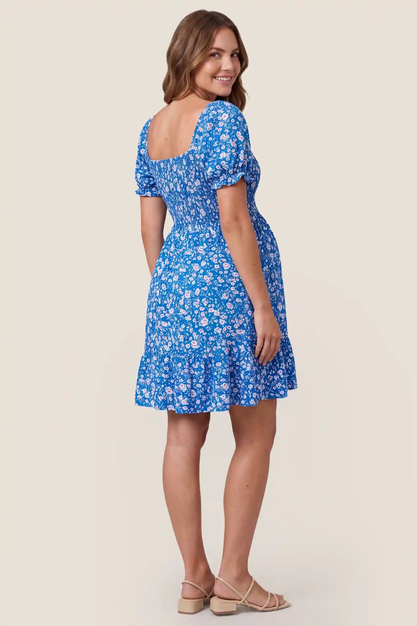 Floral Smocked Puff Sleeve Maternity Dress Floral Smocked Puff Sleeve Maternity Dress in Ocean Blue showcasing the smocked back, back view on a pregnant model.