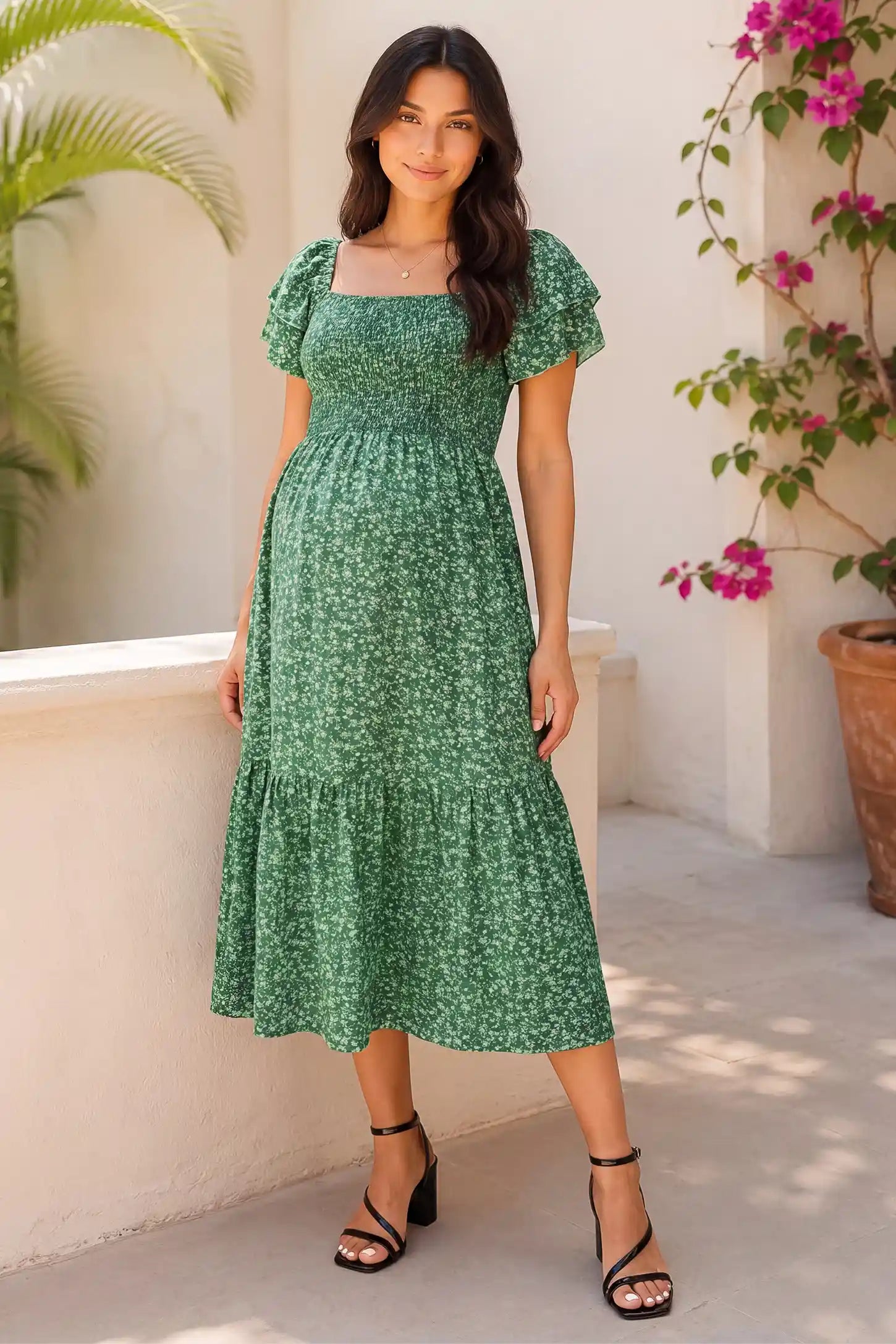 Floral Smocked Square Neck Tiered Maternity Midi Dress Floral Smocked Square Neck Tiered Maternity Midi Dress in Peacock Green with a charming floral print, lifestyle front view on a pregnant model.