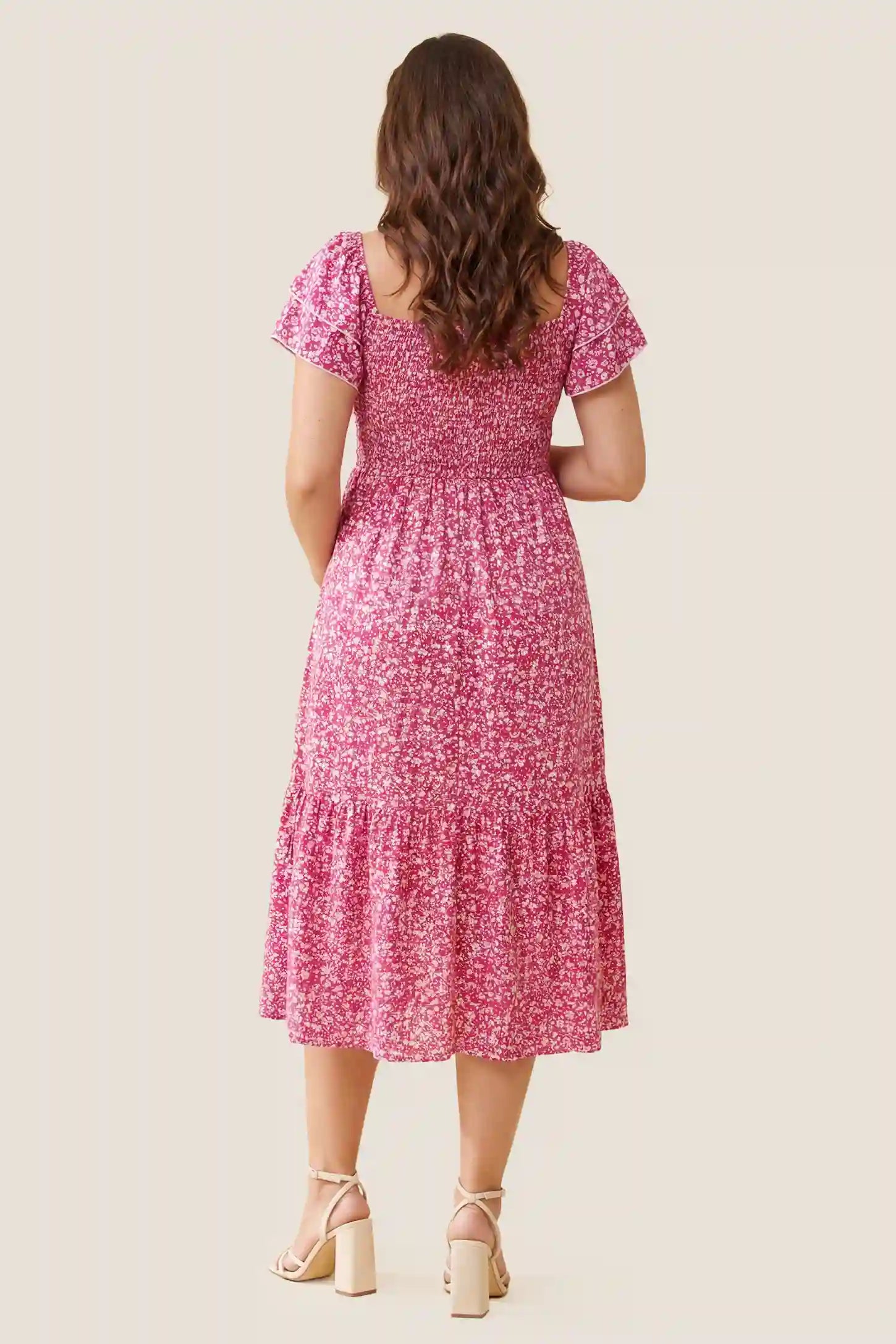 Floral Smocked Square Neck Tiered Maternity Midi Dress Floral Smocked Square Neck Tiered Maternity Midi Dress in Rose Red showcasing the back smocked panel and tiered structure, back view on a pregnant model.