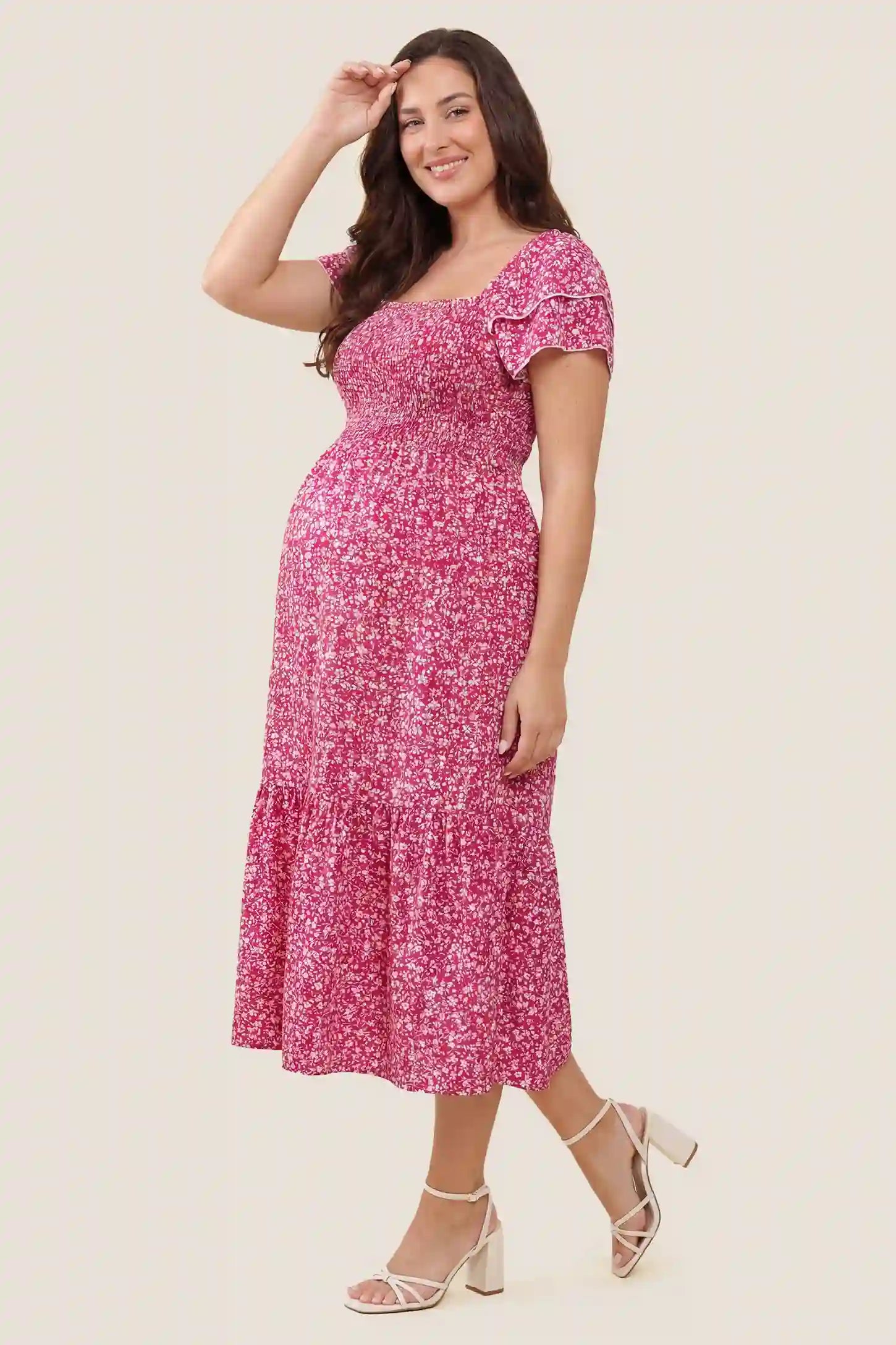 Floral Smocked Square Neck Tiered Maternity Midi Dress Floral Smocked Square Neck Tiered Maternity Midi Dress in Rose Red highlighting the high-waisted tiered profile and flowing fabric, side view on a pregnant model.