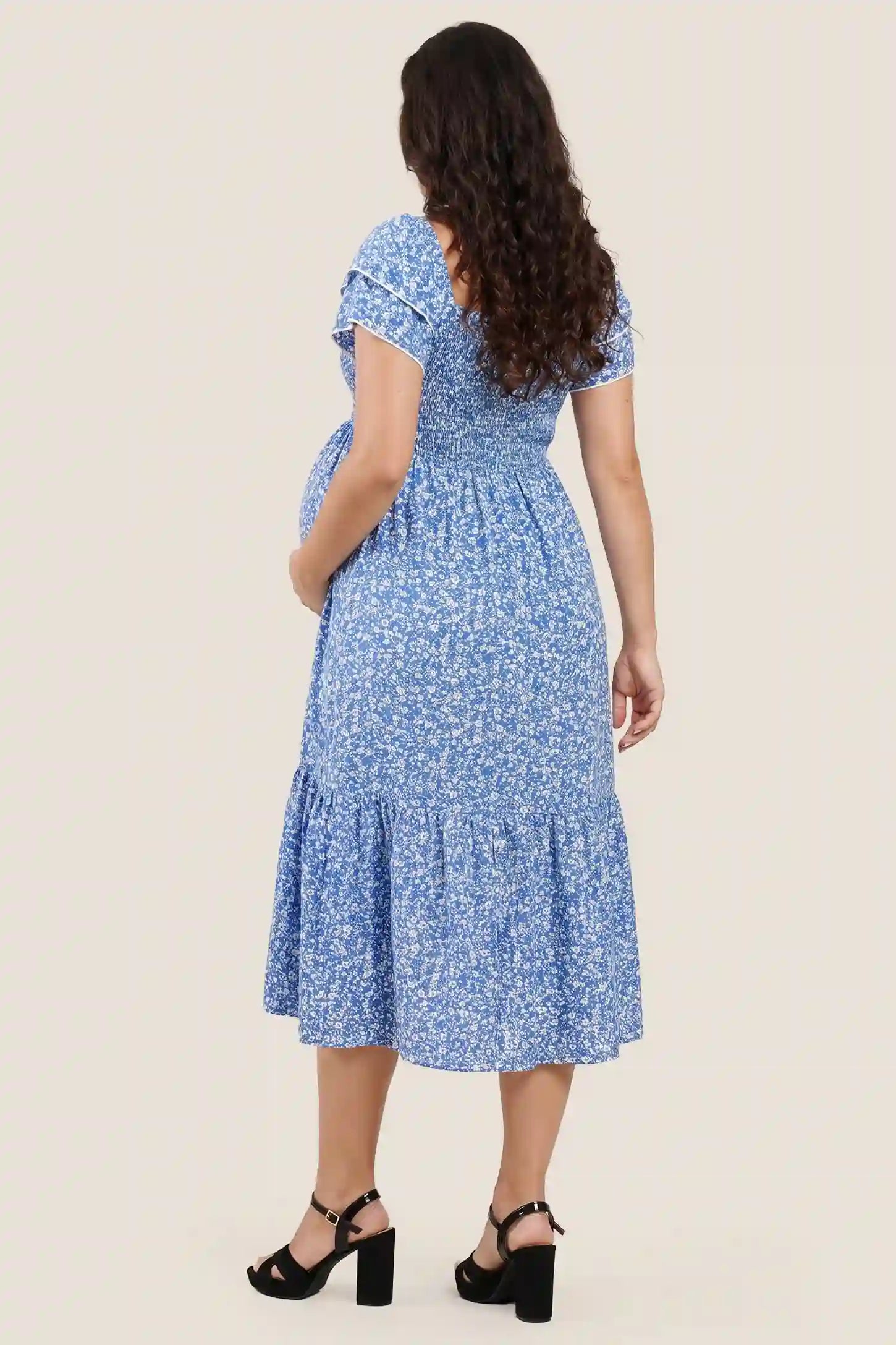 Floral Smocked Square Neck Tiered Maternity Midi Dress Floral Smocked Square Neck Tiered Maternity Midi Dress in Royal Blue highlighting the square back design, back view on a pregnant model.
