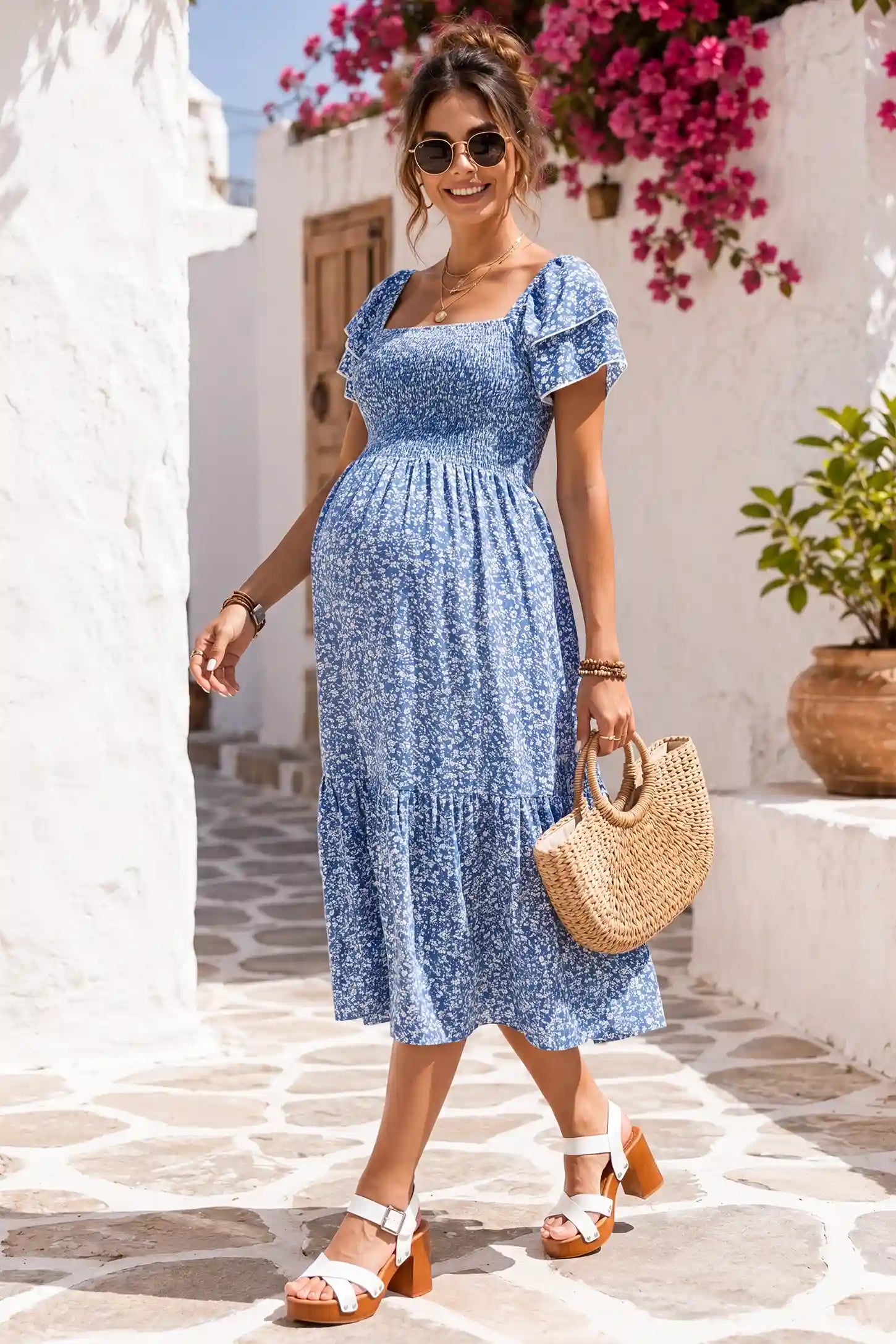 Floral Smocked Square Neck Tiered Maternity Midi Dress Floral Smocked Square Neck Tiered Maternity Midi Dress in Royal Blue with a charming floral print, lifestyle side view on a pregnant model.