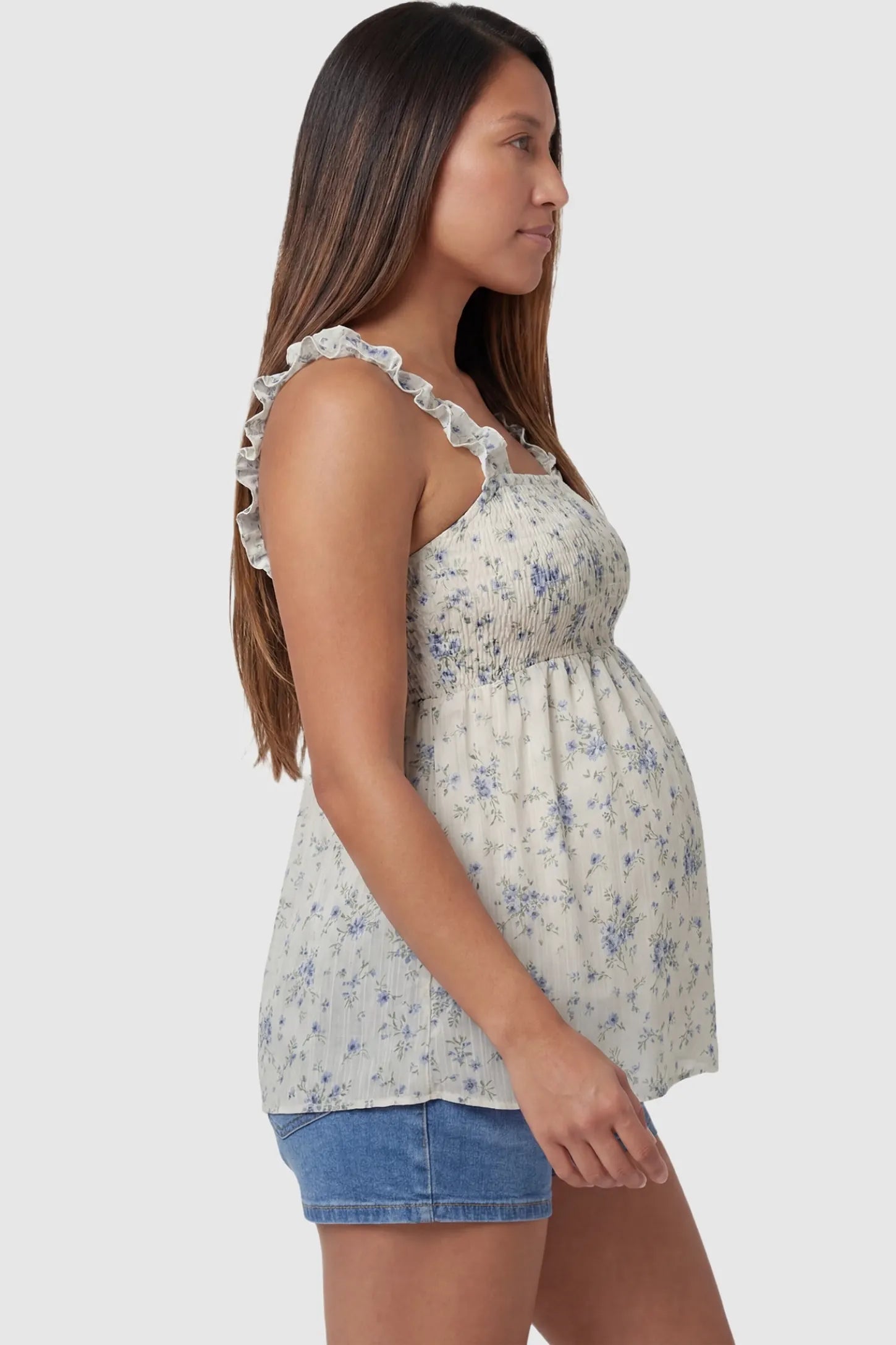 Floral Square Neck Babydoll Maternity Top in Beige featuring a flowy babydoll silhouette and ruffle straps on a pregnant model, side view.