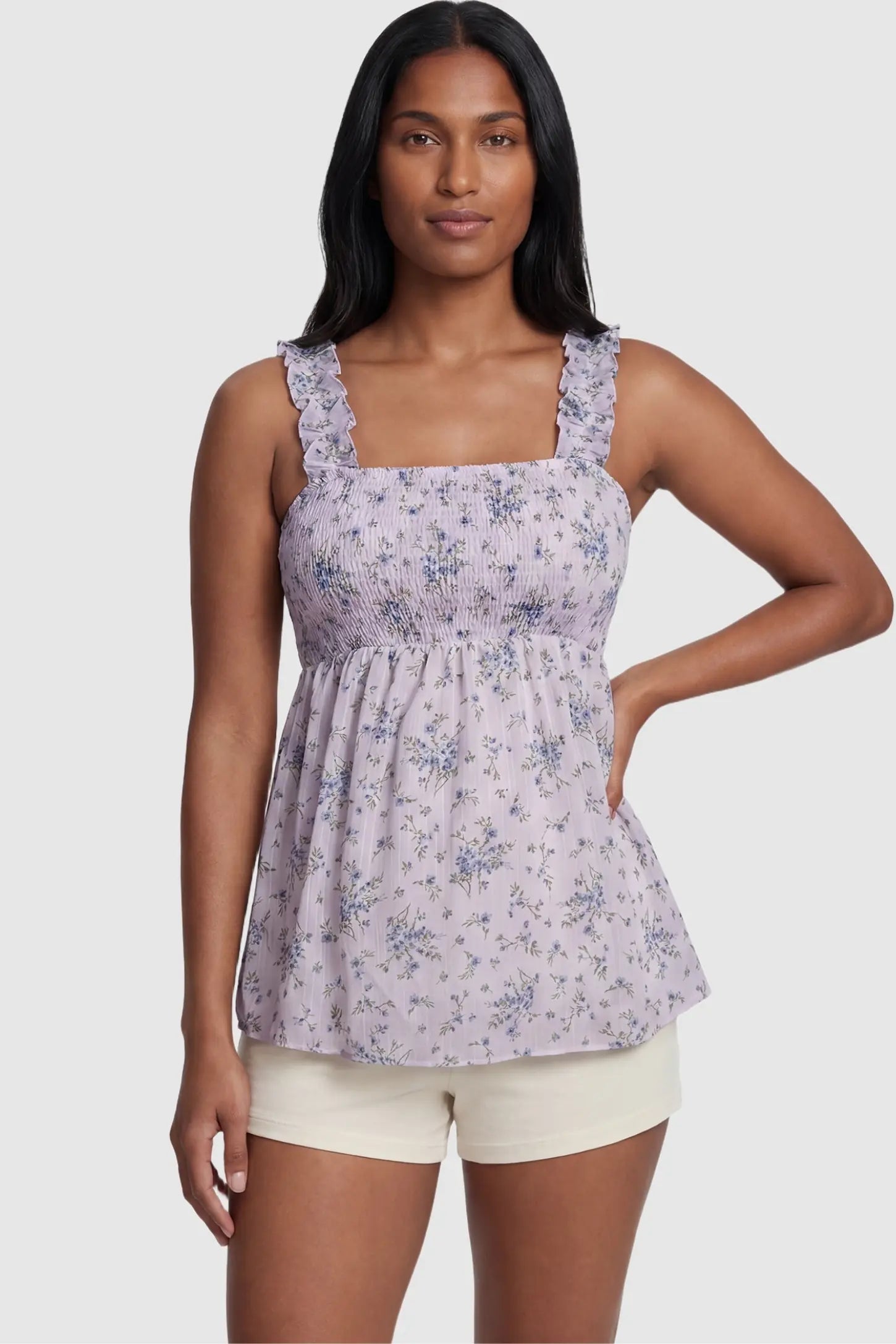 Floral Square Neck Babydoll Maternity Top Floral Square Neck Babydoll Maternity Top in Purple featuring a smocked bodice and flowy babydoll hem on a non-pregnant model, front view.