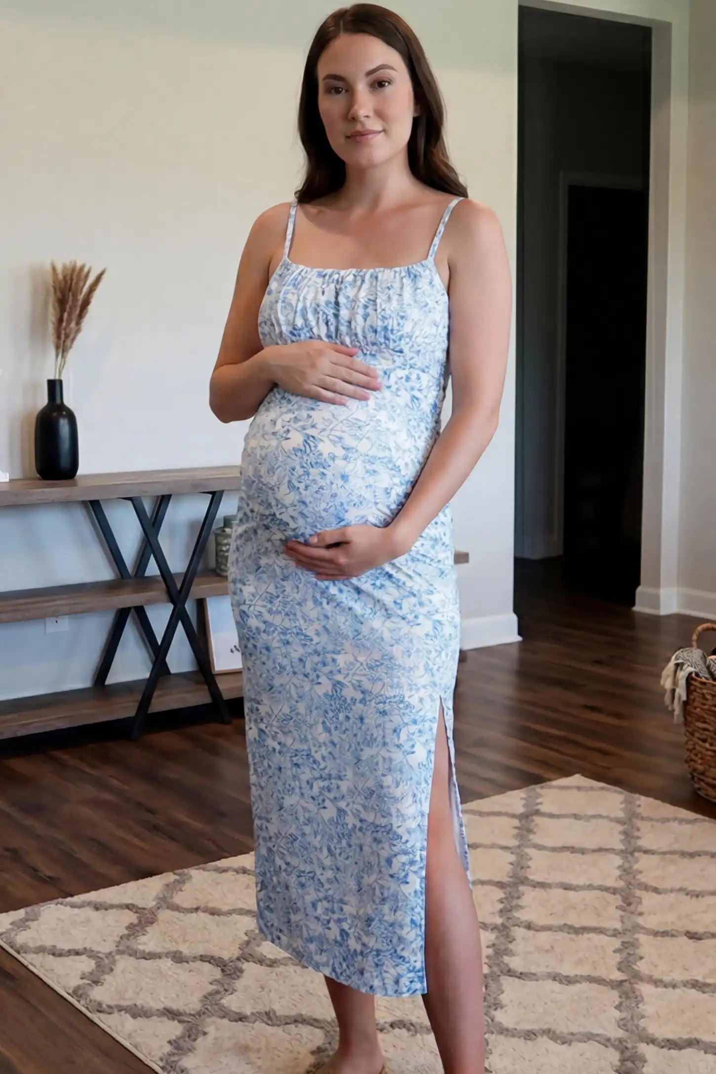 Floral Square Neck Side Ruched Maternity Midi Dress Floral Square Neck Side Ruched Maternity Midi Dress in Blue featuring a botanical print and sleeveless cut on a pregnant woman in indoor setting, front view.