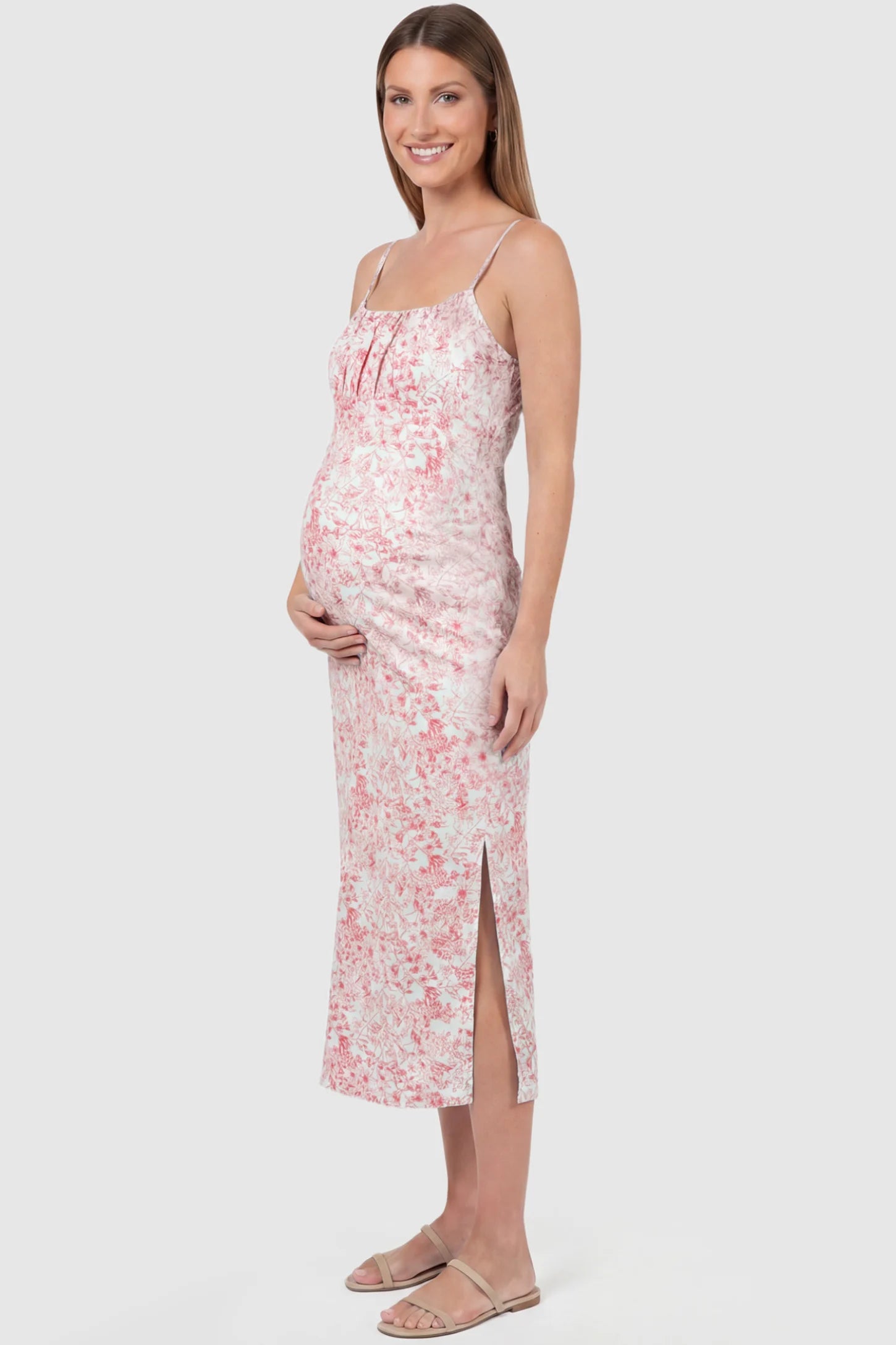 Floral Square Neck Side Ruched Maternity Midi Dress Floral Square Neck Side Ruched Maternity Midi Dress in Pink featuring a botanical print and sleeveless cut on a pregnant model, side view.