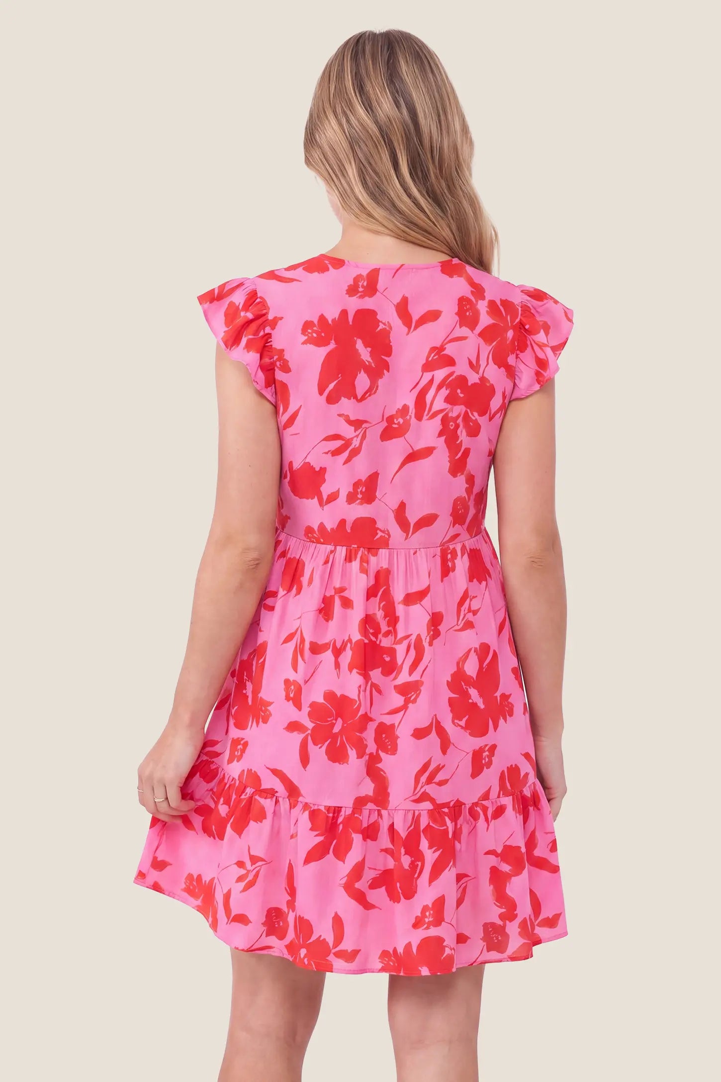Floral Print V-Neck Flutter Sleeve Maternity Short Dress Floral Print V-Neck Flutter Sleeve Maternity Short Dress in Red showcasing the flutter sleeves and tiered hem design, back view on a pregnant model.