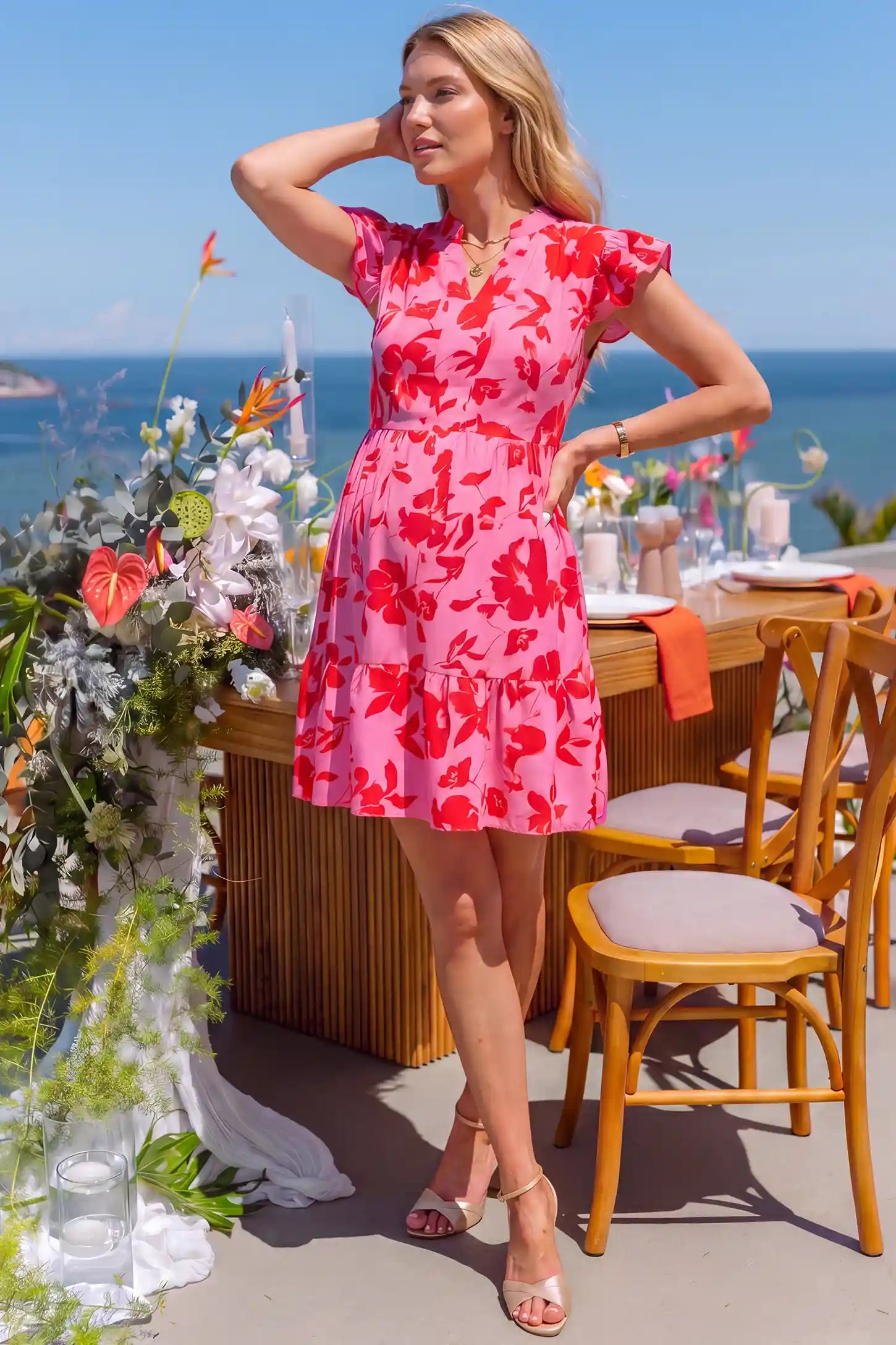 Floral Print V-Neck Flutter Sleeve Maternity Short Dress Floral Print V-Neck Flutter Sleeve Maternity Short Dress in Red with red floral pattern, lifestyle view on a pregnant model.
