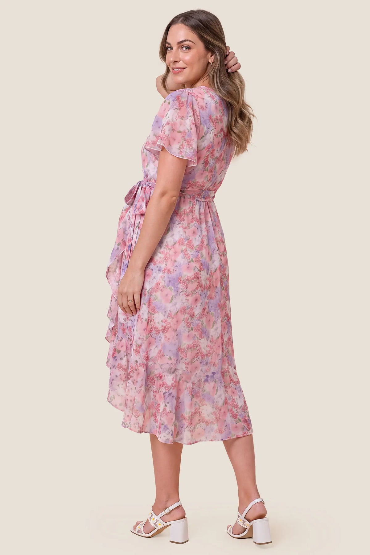 Floral V-Neck Ruffled Hem Midi Maternity Dress Floral V-Neck Ruffled Hem Midi Maternity Dress in Pink highlighting the elegant back drape and floral pattern, back view on a pregnant model.