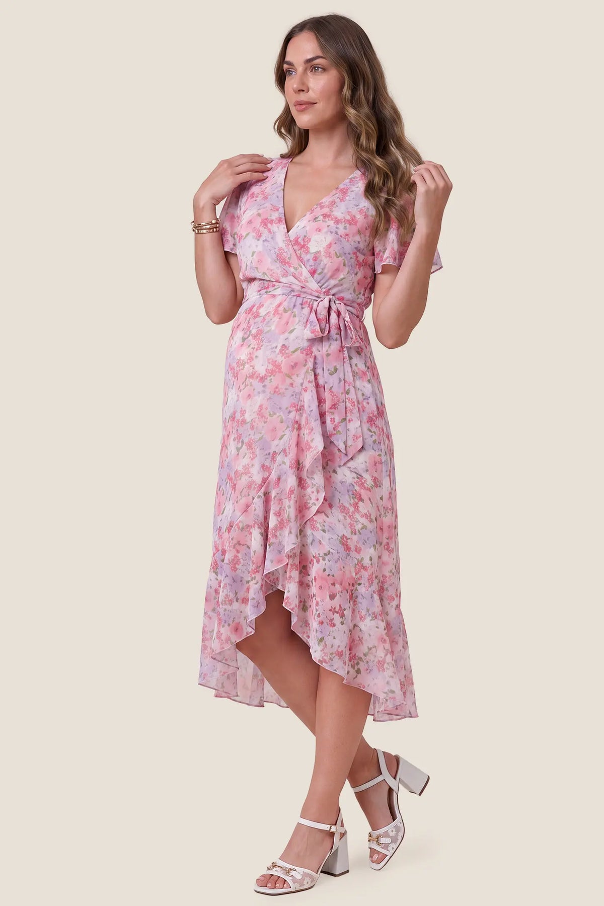 Floral V-Neck Ruffled Hem Midi Maternity Dress Floral V-Neck Ruffled Hem Midi Maternity Dress in Pink showcasing the comfortable maternity fit and midi length silhouette, side view on a pregnant model.