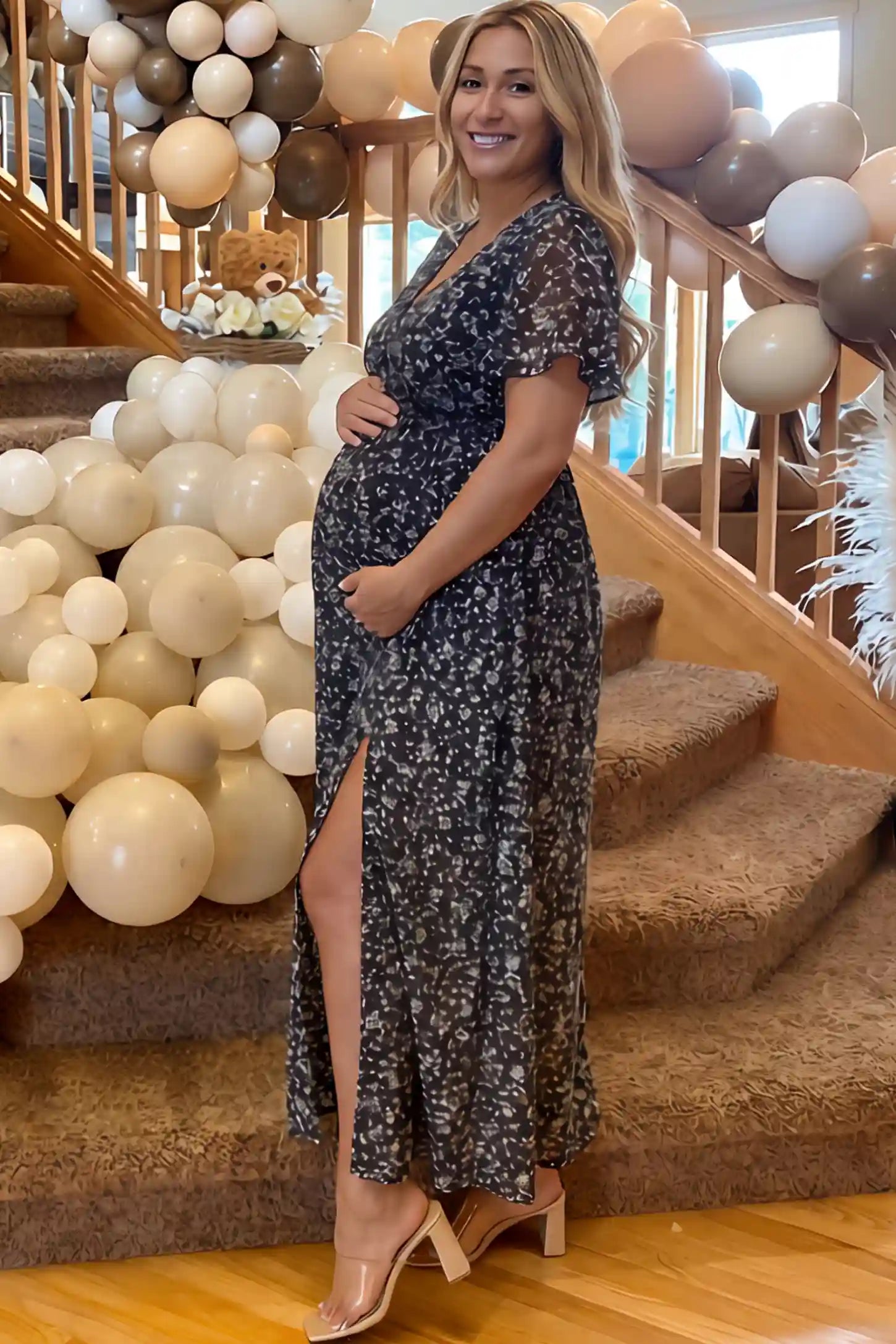 Floral V-Neck Side-Slit Maternity Maxi Dress in black featuring slit on a pregnant woman.