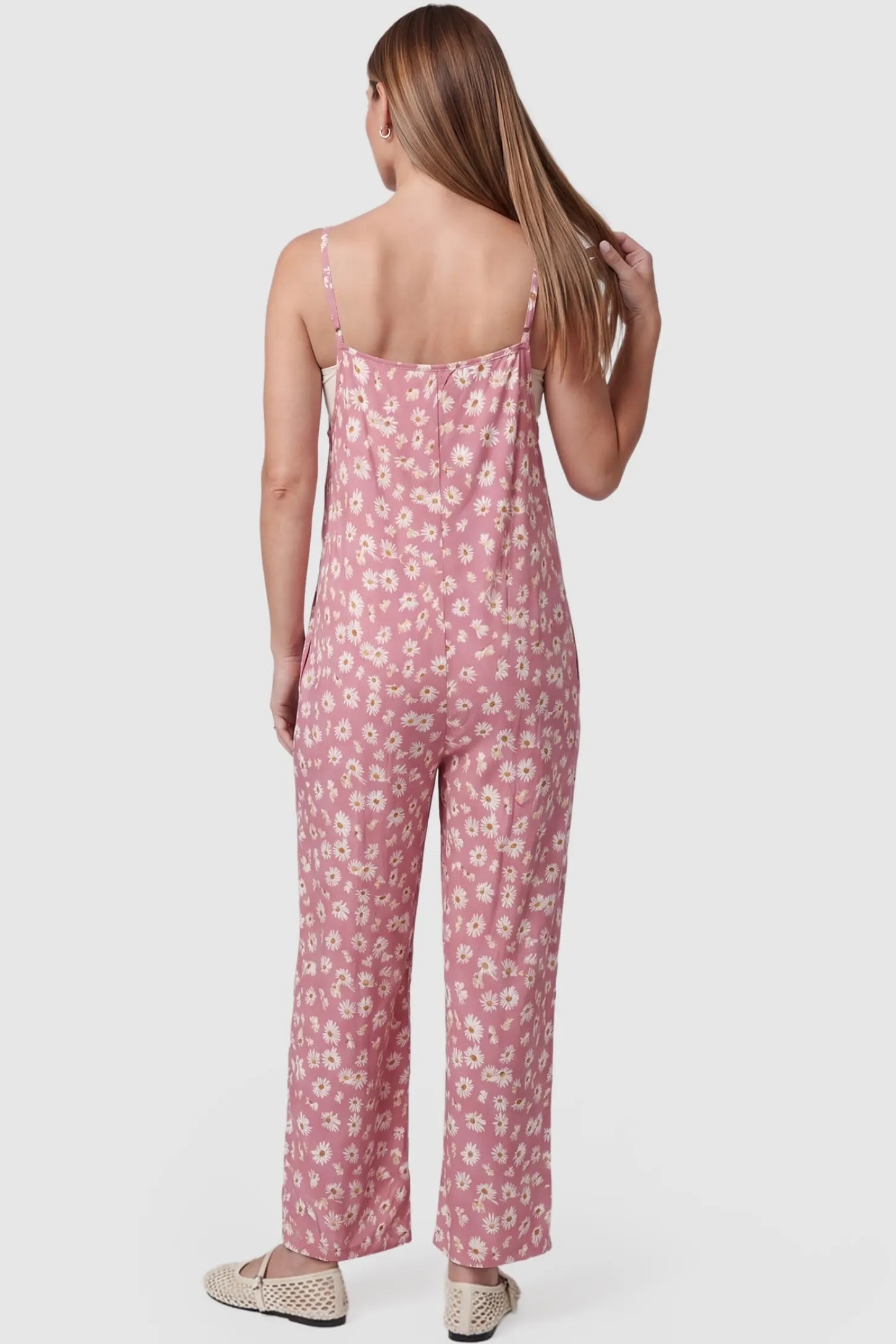Floral Wide-Leg Pocket Maternity Jumpsuit Floral Wide-Leg Pocket Jumpsuit in Pink featuring an all-over daisy print on a non-pregnant model, back view.