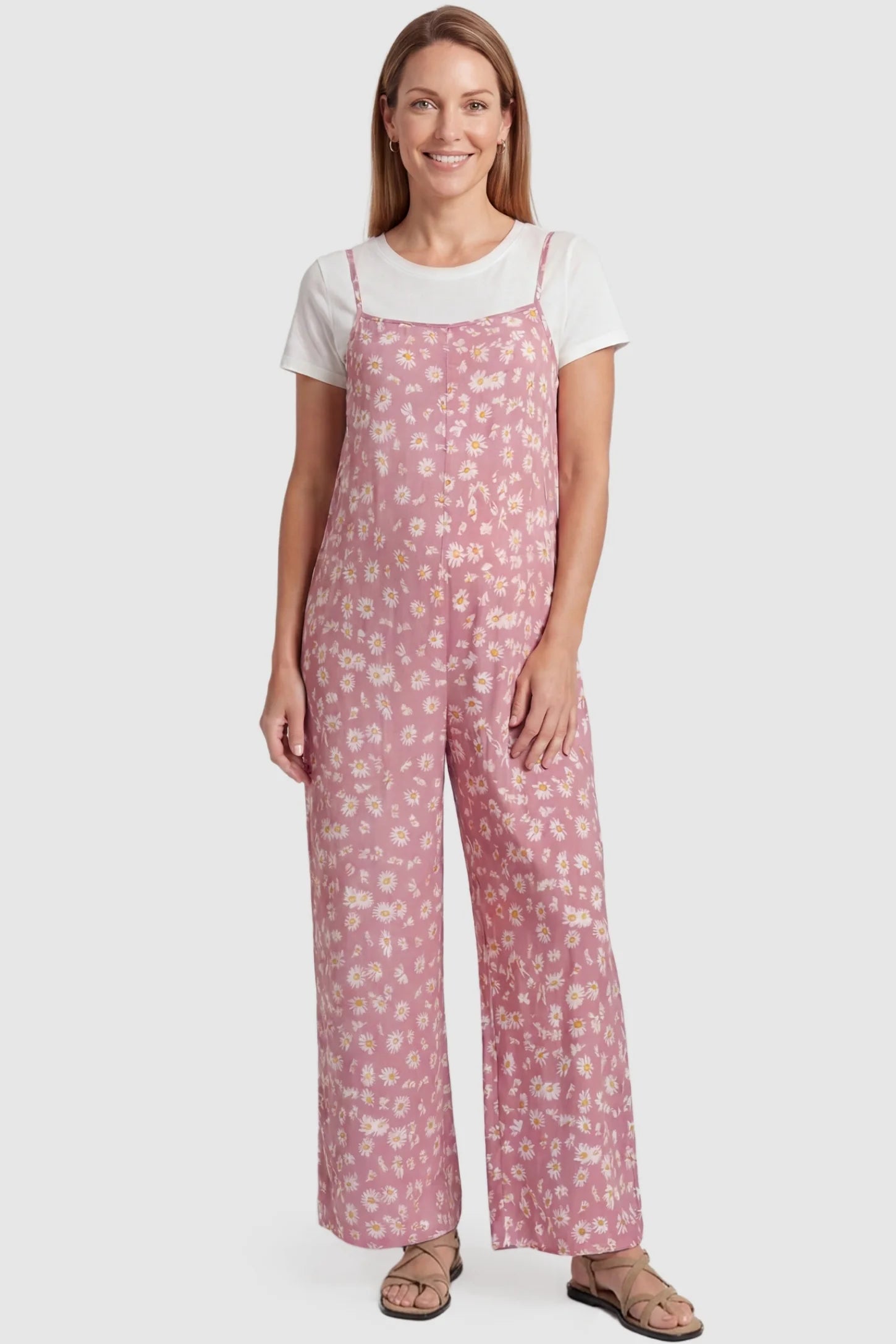 Floral Wide-Leg Pocket Maternity Jumpsuit Floral Wide-Leg Pocket Jumpsuit in Pink featuring an all-over daisy print on a non-pregnant model, postpartum view.