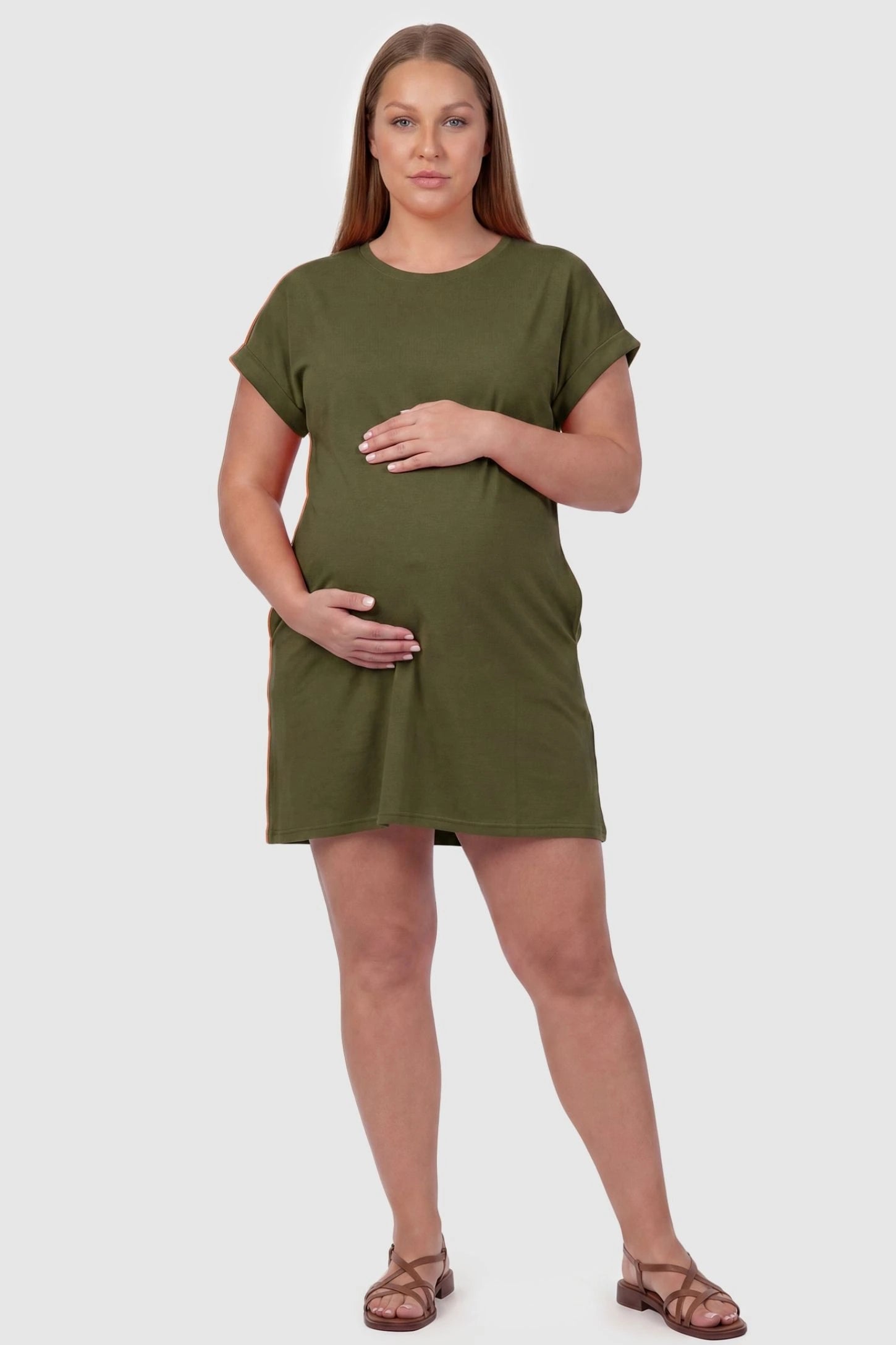 Flowy Pocket Tunic Maternity T-Shirt Dress Flowy Pocket Tunic Maternity T-Shirt Dress in Army Green featuring cuffed short sleeves on a front-view plus size model.