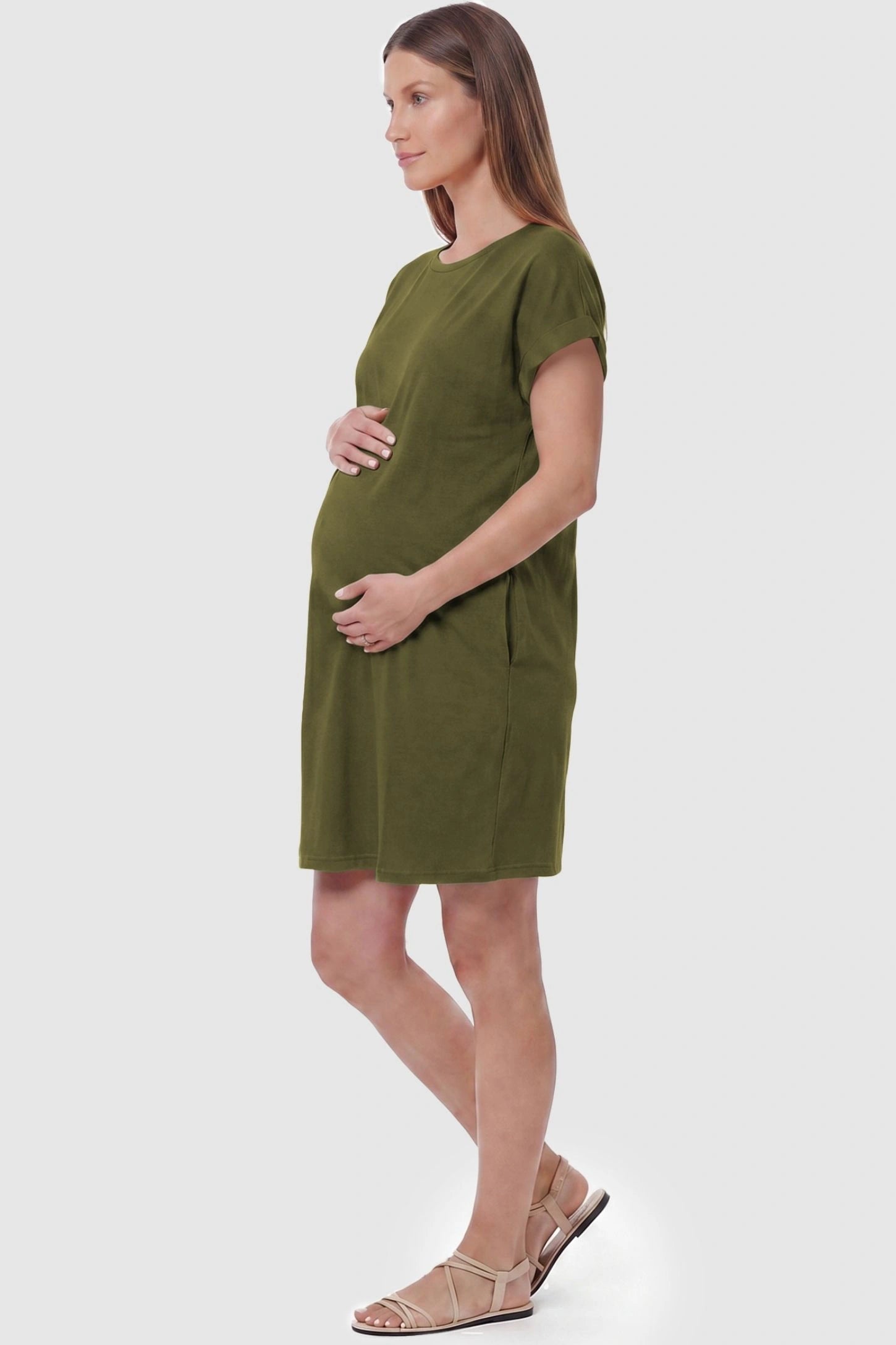 Flowy Pocket Tunic Maternity T-Shirt Dress Flowy Pocket Tunic Maternity T-Shirt Dress in Army Green featuring functional side pockets on a side-view pregnant model.