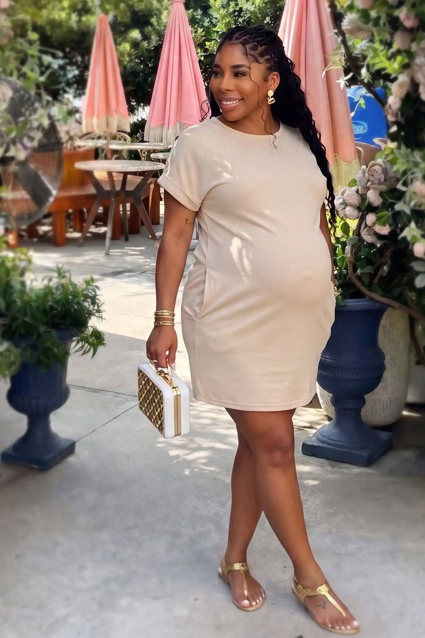 Flowy Pocket Tunic Maternity T-Shirt Dress Flowy Pocket Tunic Maternity T-Shirt Dress in Beige featuring a relaxed fit on a front-view pregnant model.