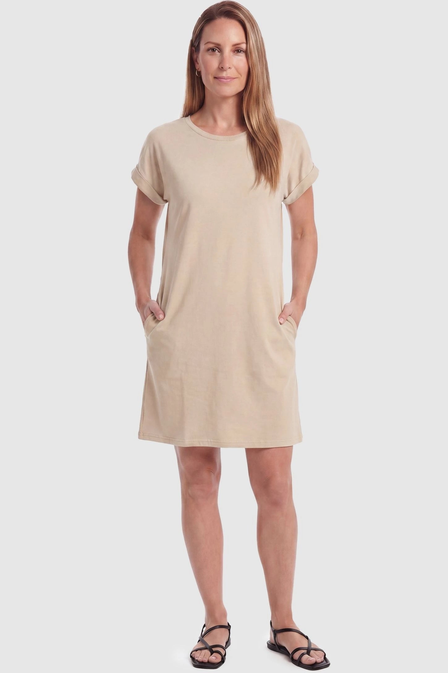 Flowy Pocket Tunic Maternity T-Shirt Dress Flowy Pocket Tunic Maternity T-Shirt Dress in Beige featuring cuffed short sleeves on a front-view postpartum model.