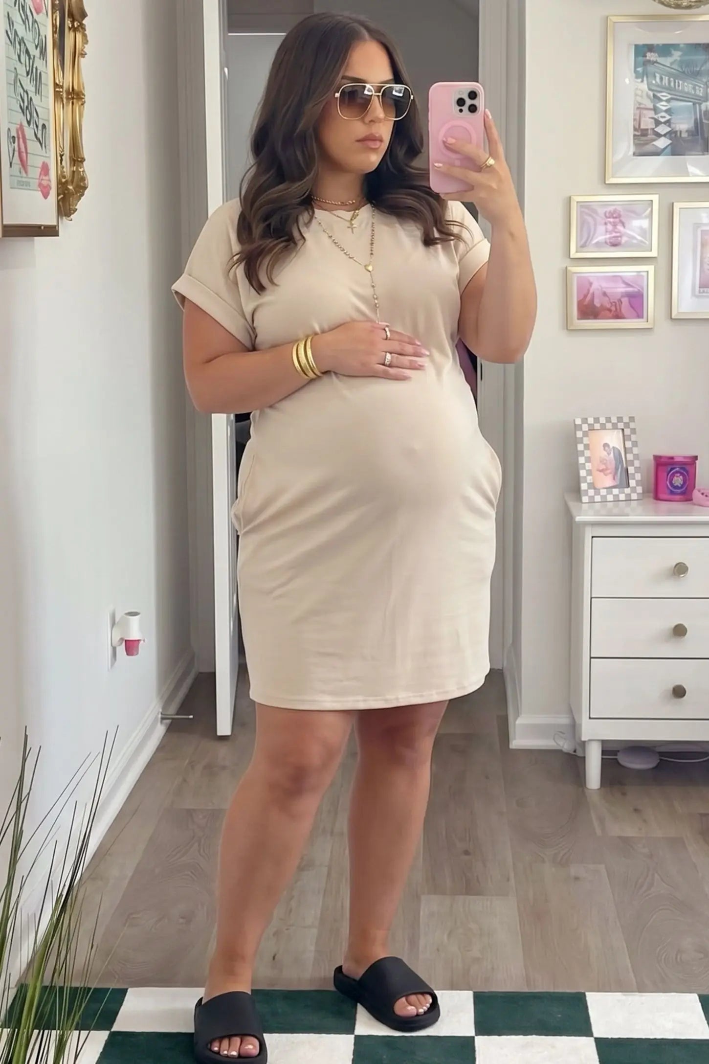 Flowy Pocket Tunic Maternity T-Shirt Dress Flowy Pocket Tunic Maternity T-Shirt Dress in Beige featuring a relaxed fit on a front-view pregnant model.