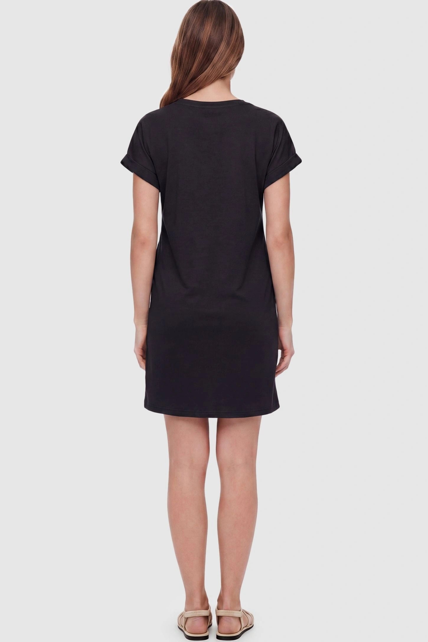 Flowy Pocket Tunic Maternity T-Shirt Dress Flowy Pocket Tunic Maternity T-Shirt Dress in Black featuring a classic crew neckline on a back-view model.