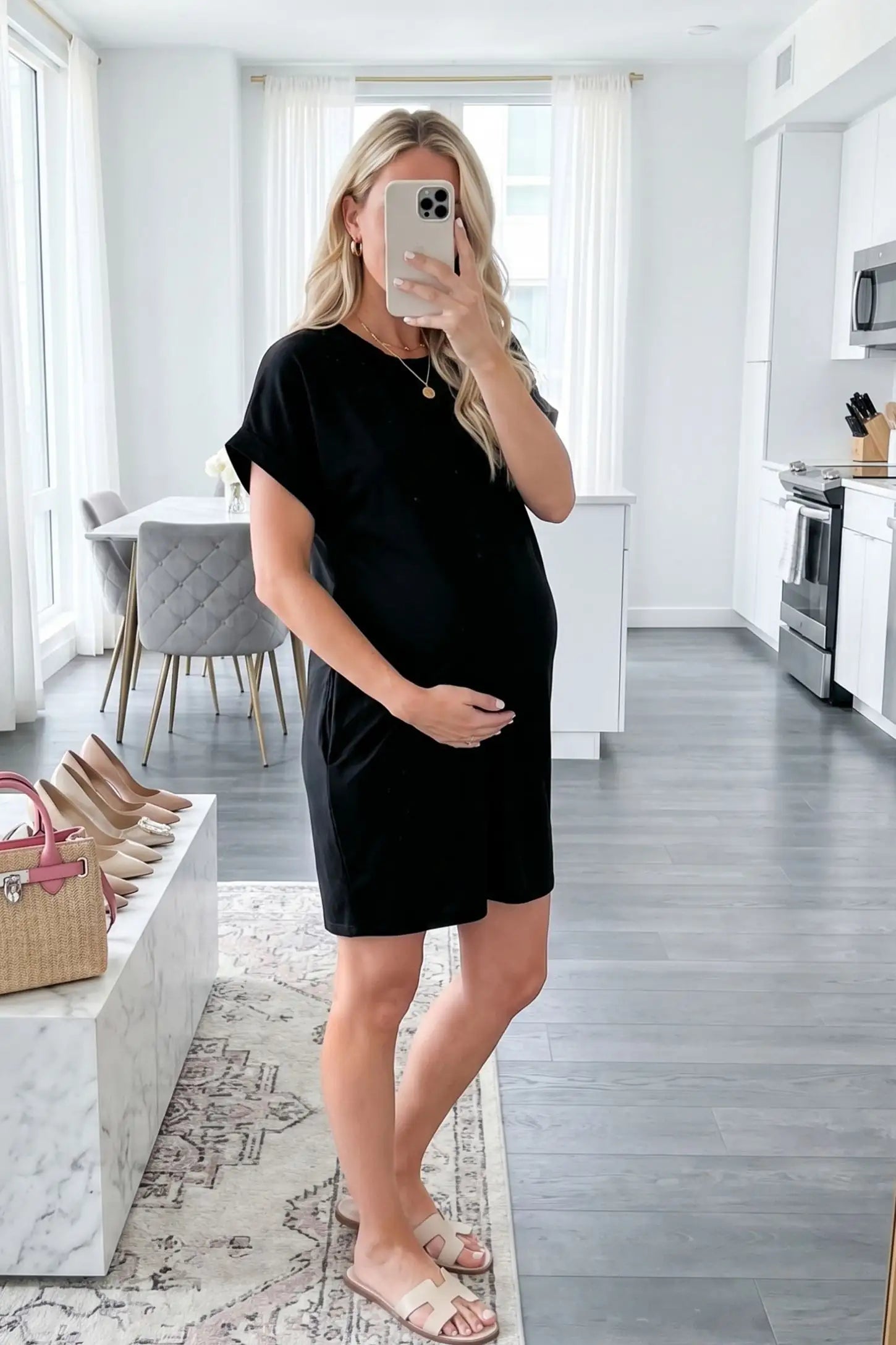 Flowy Pocket Tunic Maternity T-Shirt Dress Flowy Pocket Tunic Maternity T-Shirt Dress in Black featuring a relaxed fit on a front-view pregnant model.