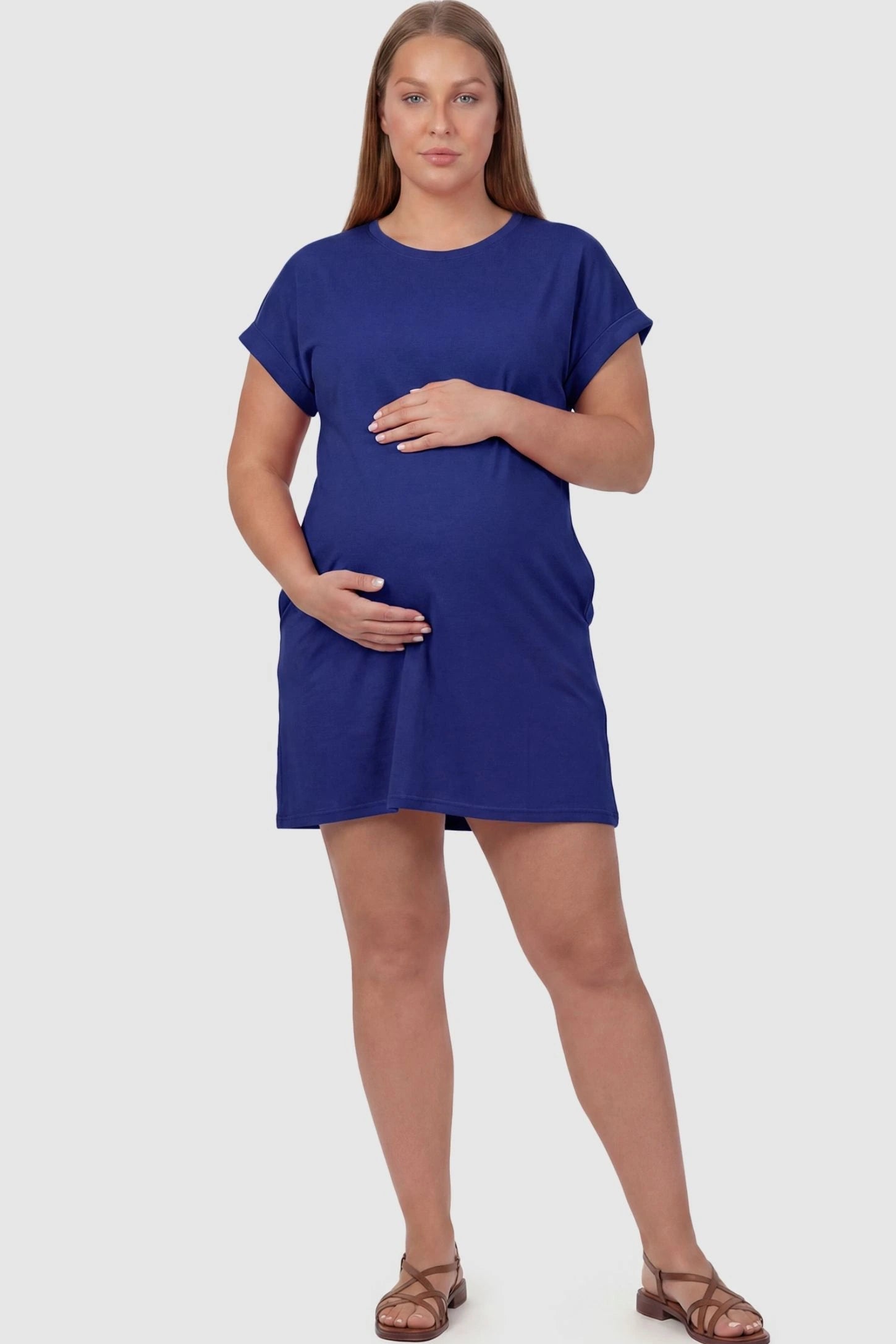Flowy Pocket Tunic Maternity T-Shirt Dress Flowy Pocket Tunic Maternity T-Shirt Dress in Blue featuring cuffed short sleeves on a front-view plus size model.