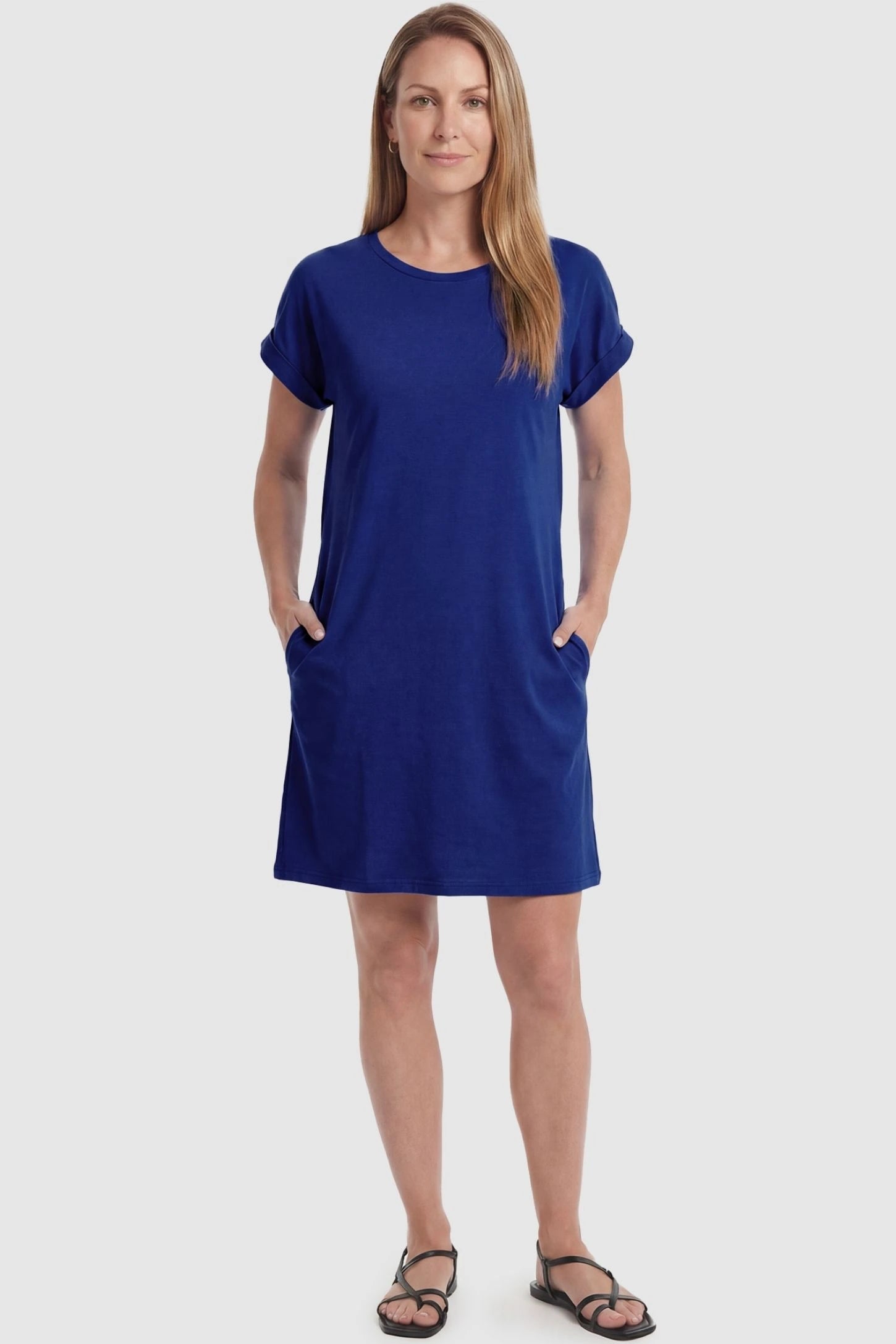 Flowy Pocket Tunic Maternity T-Shirt Dress Flowy Pocket Tunic Maternity T-Shirt Dress in Blue featuring cuffed short sleeves on a front-view postpartum model.