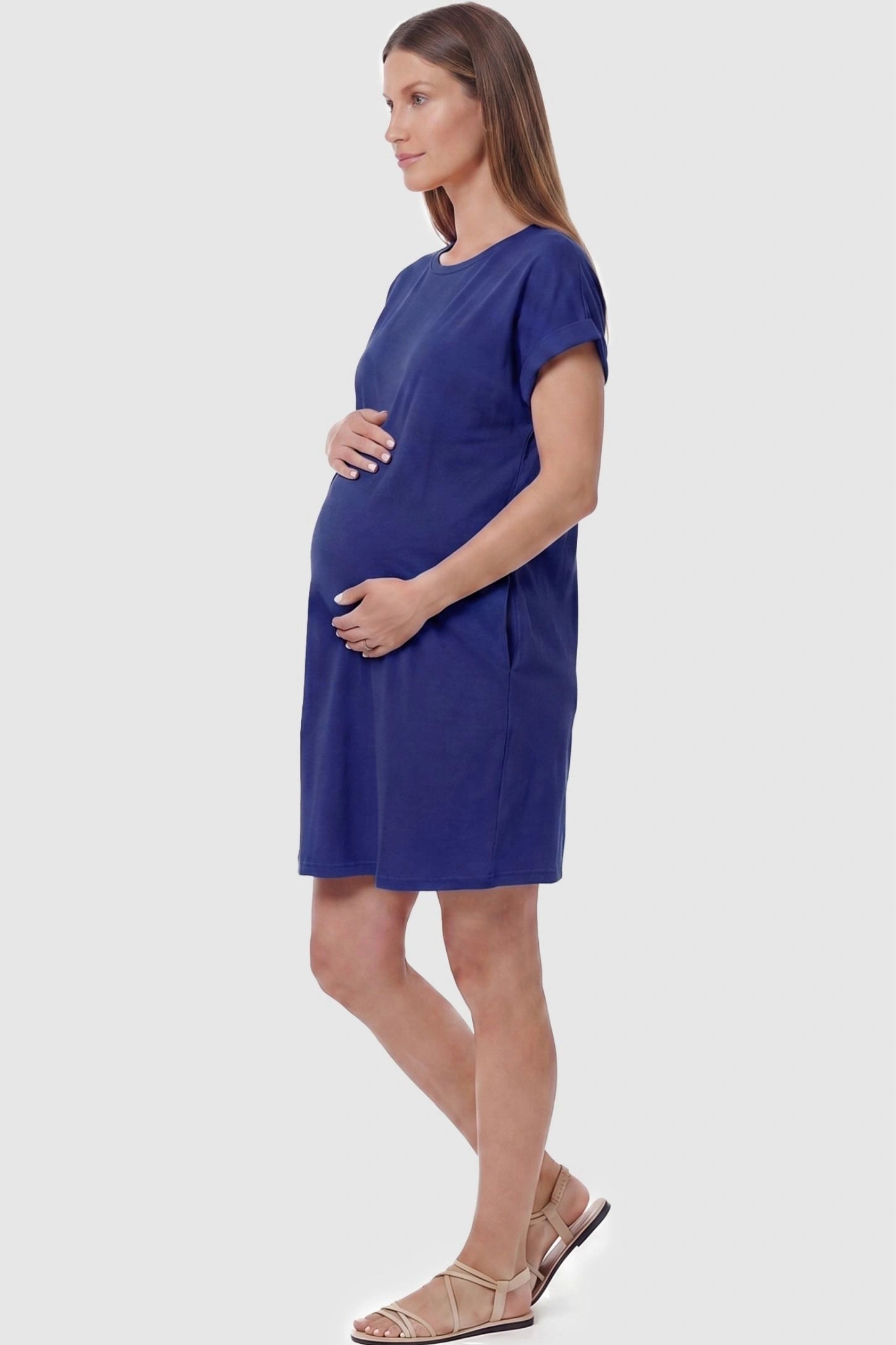 Flowy Pocket Tunic Maternity T-Shirt Dress Flowy Pocket Tunic Maternity T-Shirt Dress in Blue featuring functional side pockets on a side-view pregnant model.