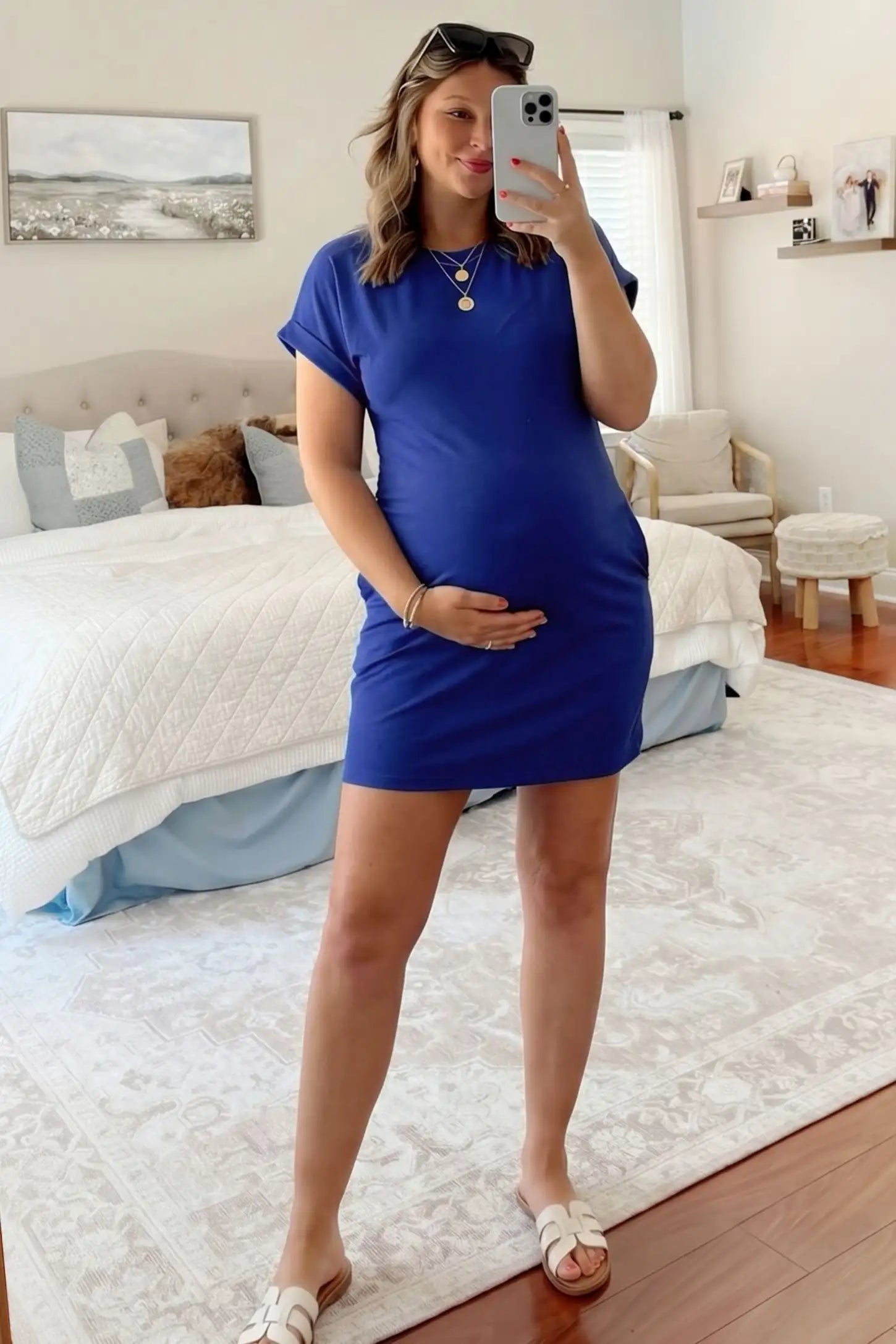 Flowy Pocket Tunic Maternity T-Shirt Dress Flowy Pocket Tunic Maternity T-Shirt Dress in Blue featuring a relaxed fit on a front-view pregnant model.
