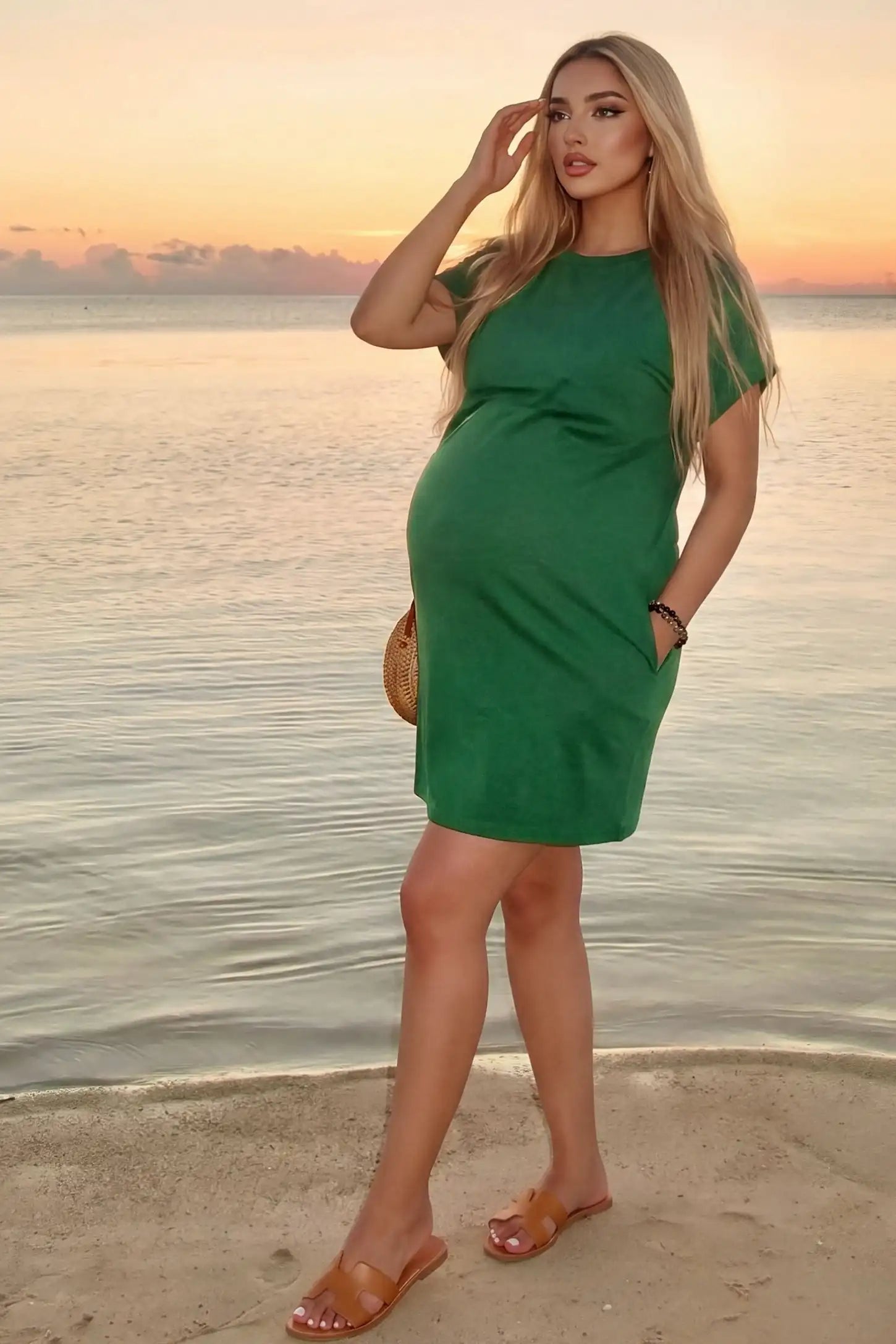 Flowy Pocket Tunic Maternity T-Shirt Dress Flowy Pocket Tunic Maternity T-Shirt Dress in Green featuring a relaxed fit on a front-view pregnant model.