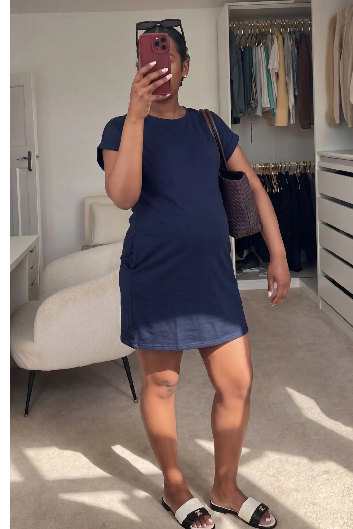 Flowy Pocket Tunic Maternity T-Shirt Dress Flowy Pocket Tunic Maternity T-Shirt Dress in Navy Blue featuring a relaxed fit on a front-view pregnant model.