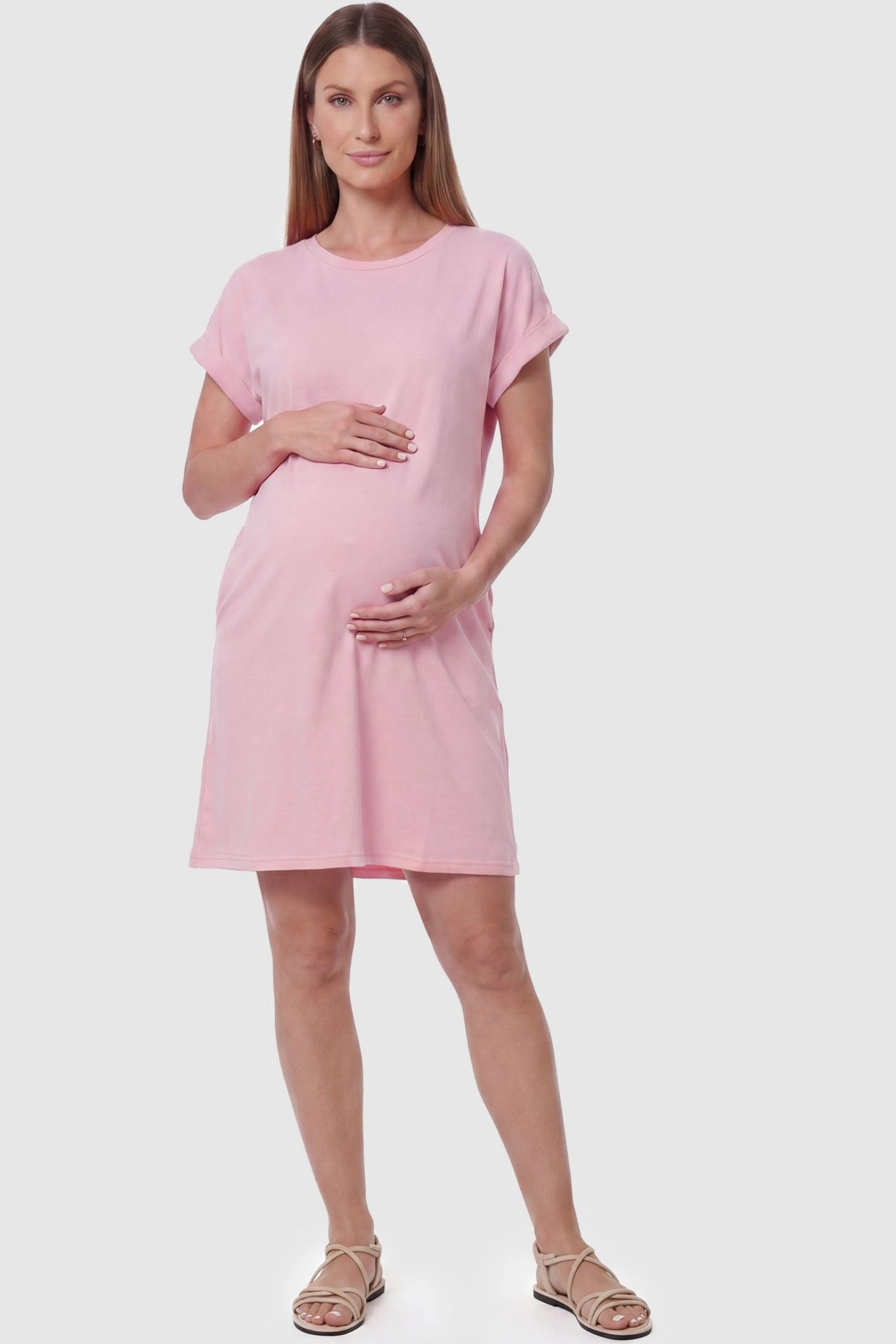 Flowy Pocket Tunic Maternity T-Shirt Dress Flowy Pocket Tunic Maternity T-Shirt Dress in Pink featuring a relaxed fit on a front-view pregnant model.