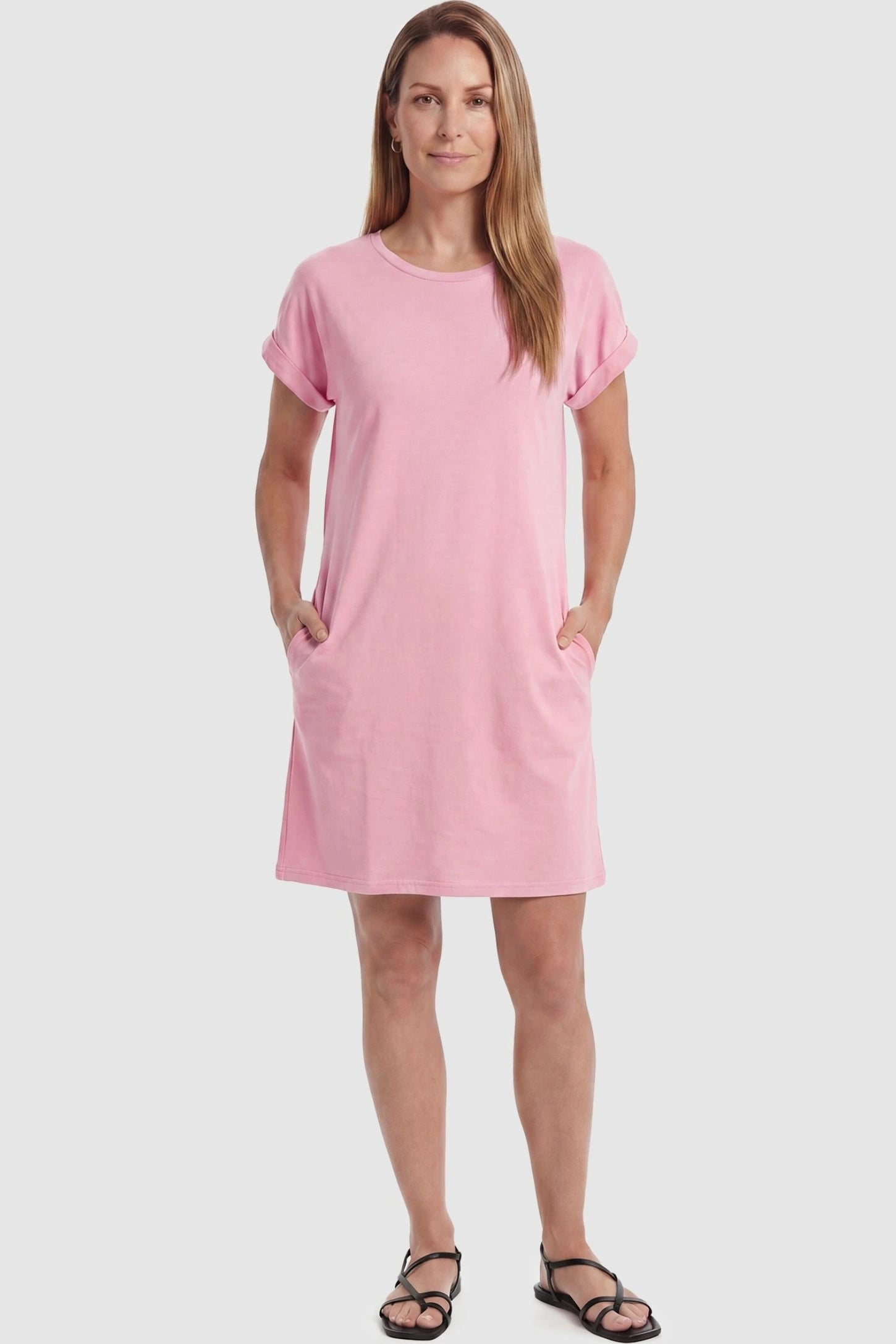 Flowy Pocket Tunic Maternity T-Shirt Dress Flowy Pocket Tunic Maternity T-Shirt Dress in Pink featuring cuffed short sleeves on a front-view postpartum model.