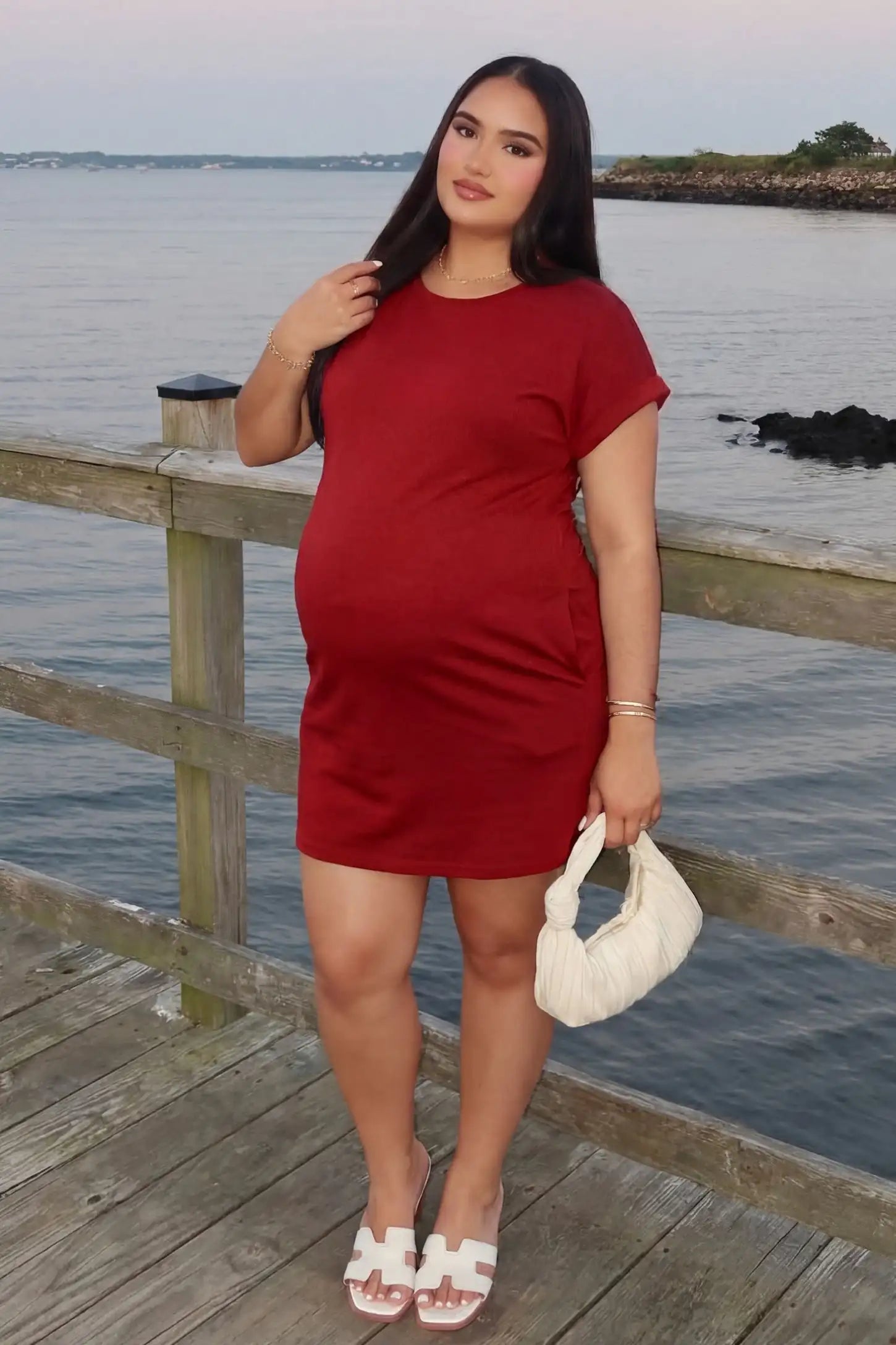 Flowy Pocket Tunic Maternity T-Shirt Dress Flowy Pocket Tunic Maternity T-Shirt Dress in Red featuring a relaxed fit on a front-view pregnant model.