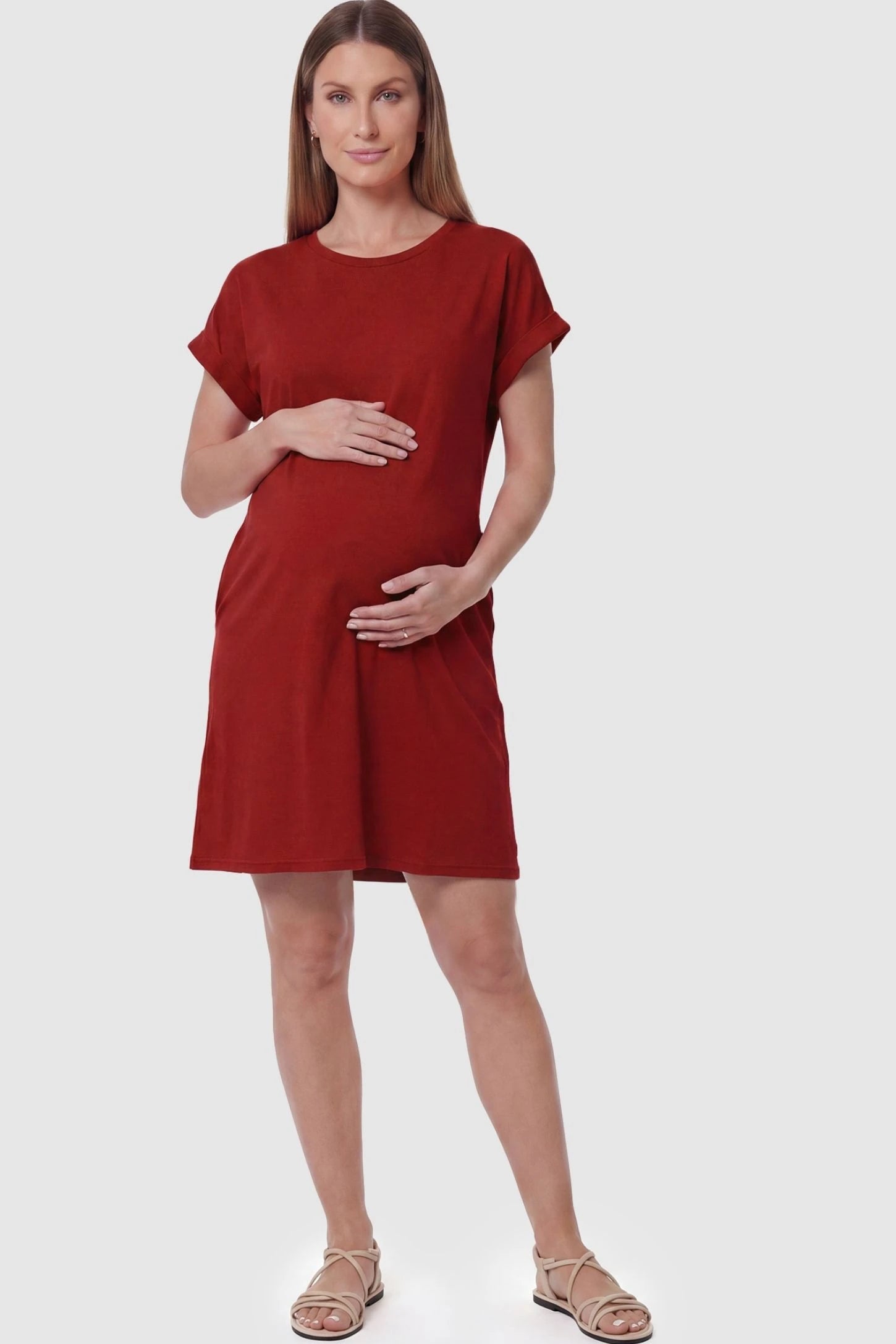 Flowy Pocket Tunic Maternity T-Shirt Dress Flowy Pocket Tunic Maternity T-Shirt Dress in Red featuring a relaxed fit on a front-view pregnant model.