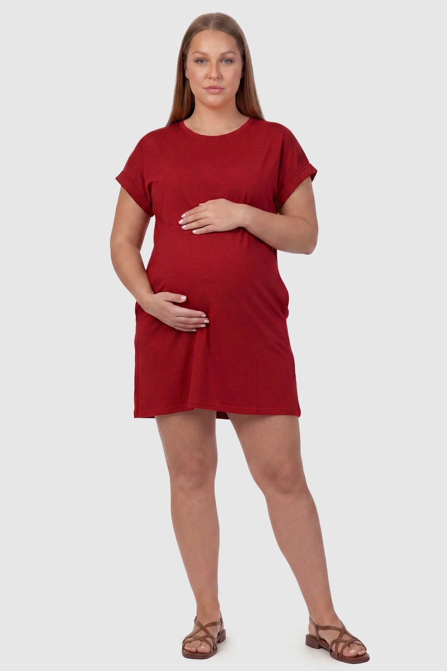 Flowy Pocket Tunic Maternity T-Shirt Dress Flowy Pocket Tunic Maternity T-Shirt Dress in Red featuring cuffed short sleeves on a front-view plus size model.