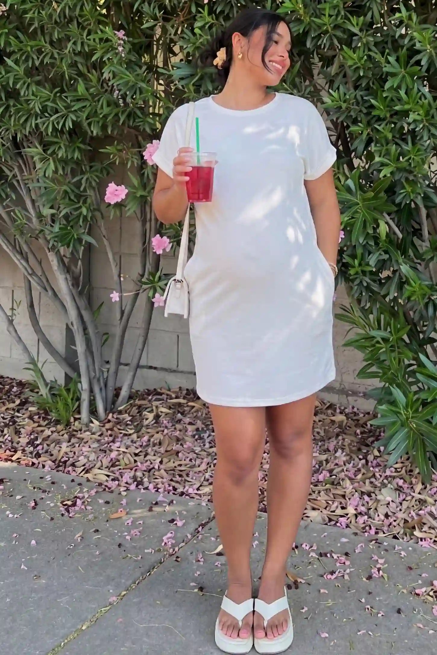 Flowy Pocket Tunic Maternity T-Shirt Dress Flowy Pocket Tunic Maternity T-Shirt Dress in White featuring a relaxed fit on a front-view pregnant model.