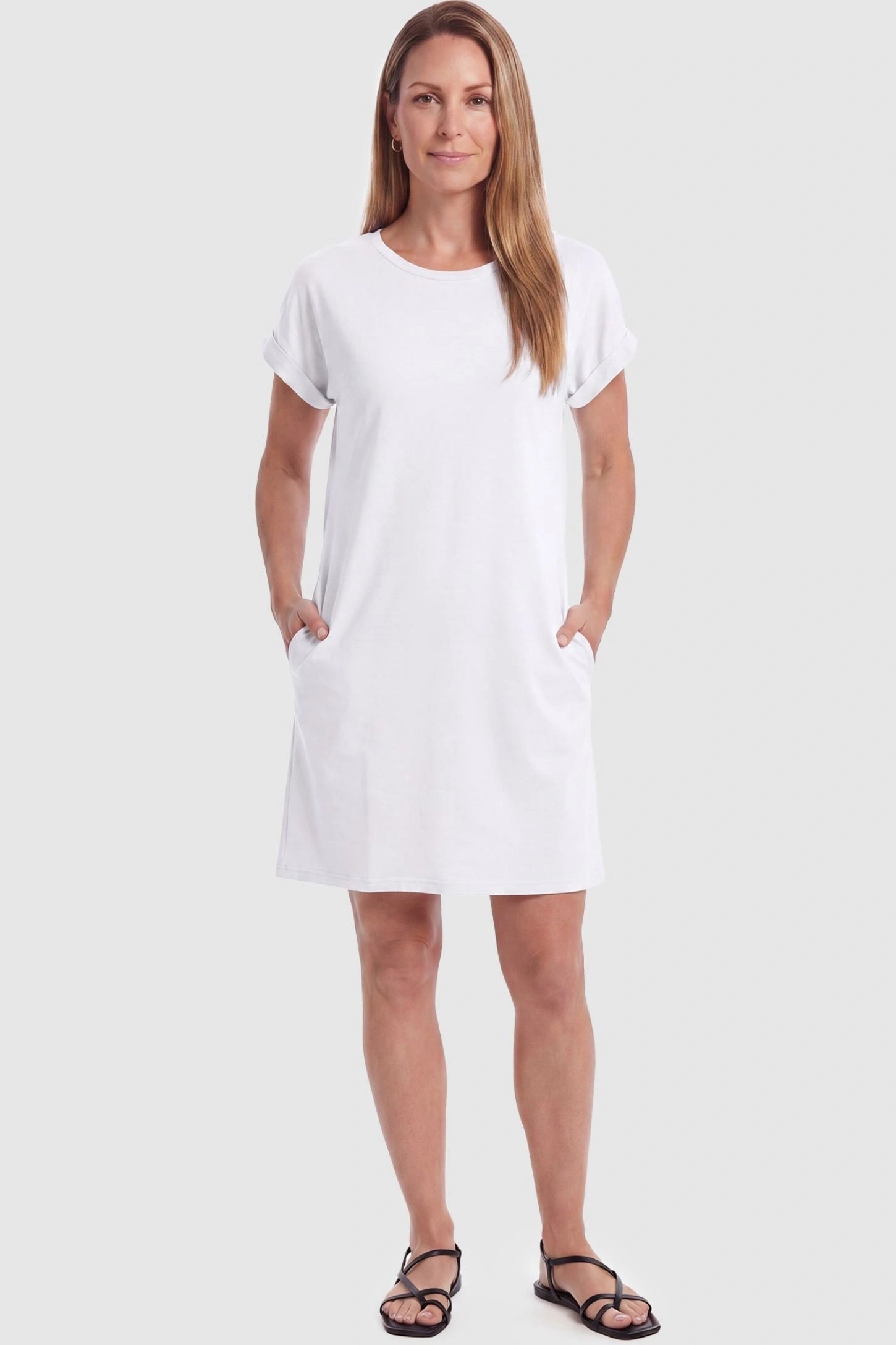 Flowy Pocket Tunic Maternity T-Shirt Dress Flowy Pocket Tunic Maternity T-Shirt Dress in White featuring cuffed short sleeves on a front-view postpartum model.