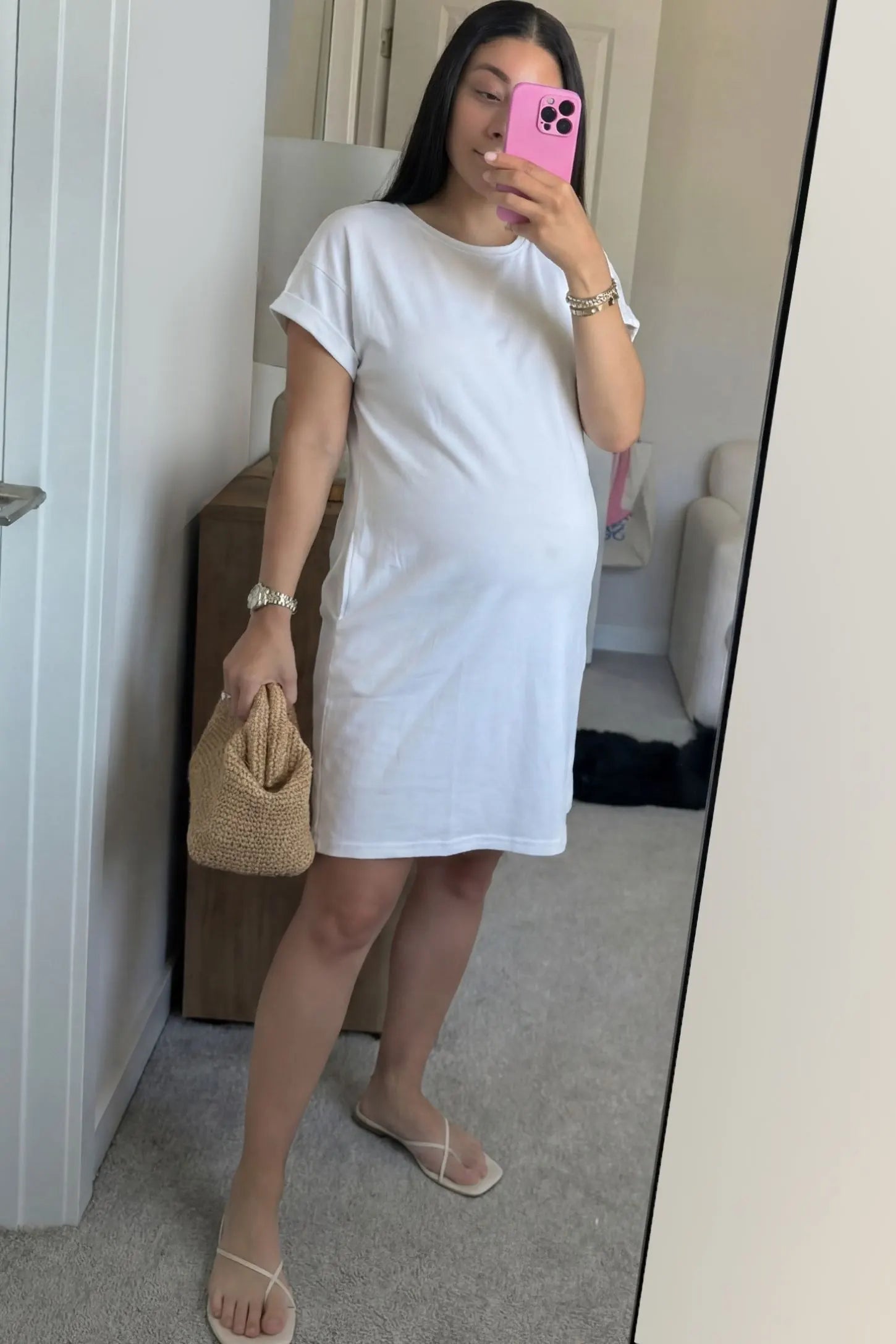 Flowy Pocket Tunic Maternity T-Shirt Dress Flowy Pocket Tunic Maternity T-Shirt Dress in White featuring a relaxed fit on a front-view pregnant model.