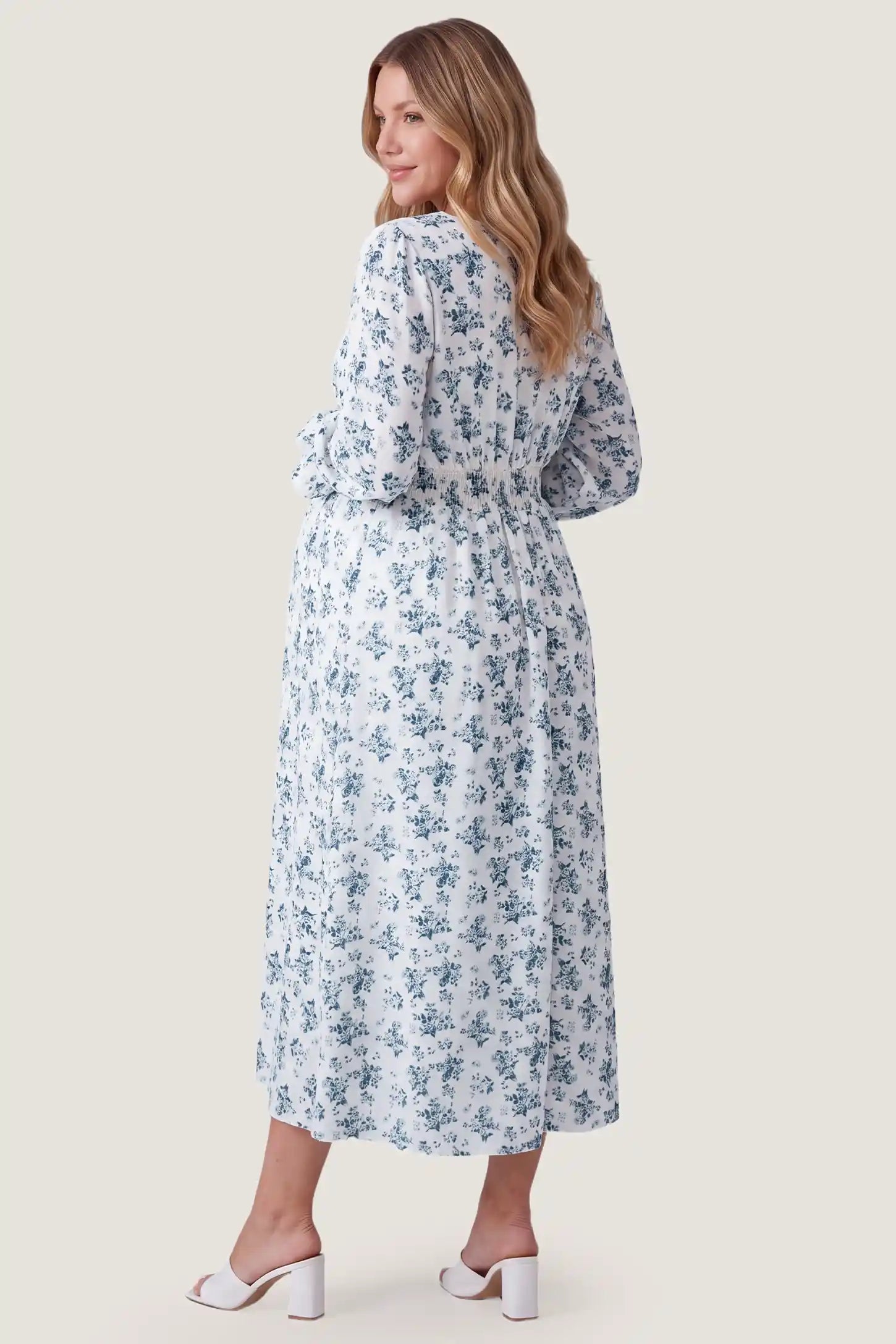 French Blue Floral V-Neck Maternity Dress French Blue Floral V-Neck Maternity Dress in French Blue Floral showcasing back design, back view on a pregnant model.