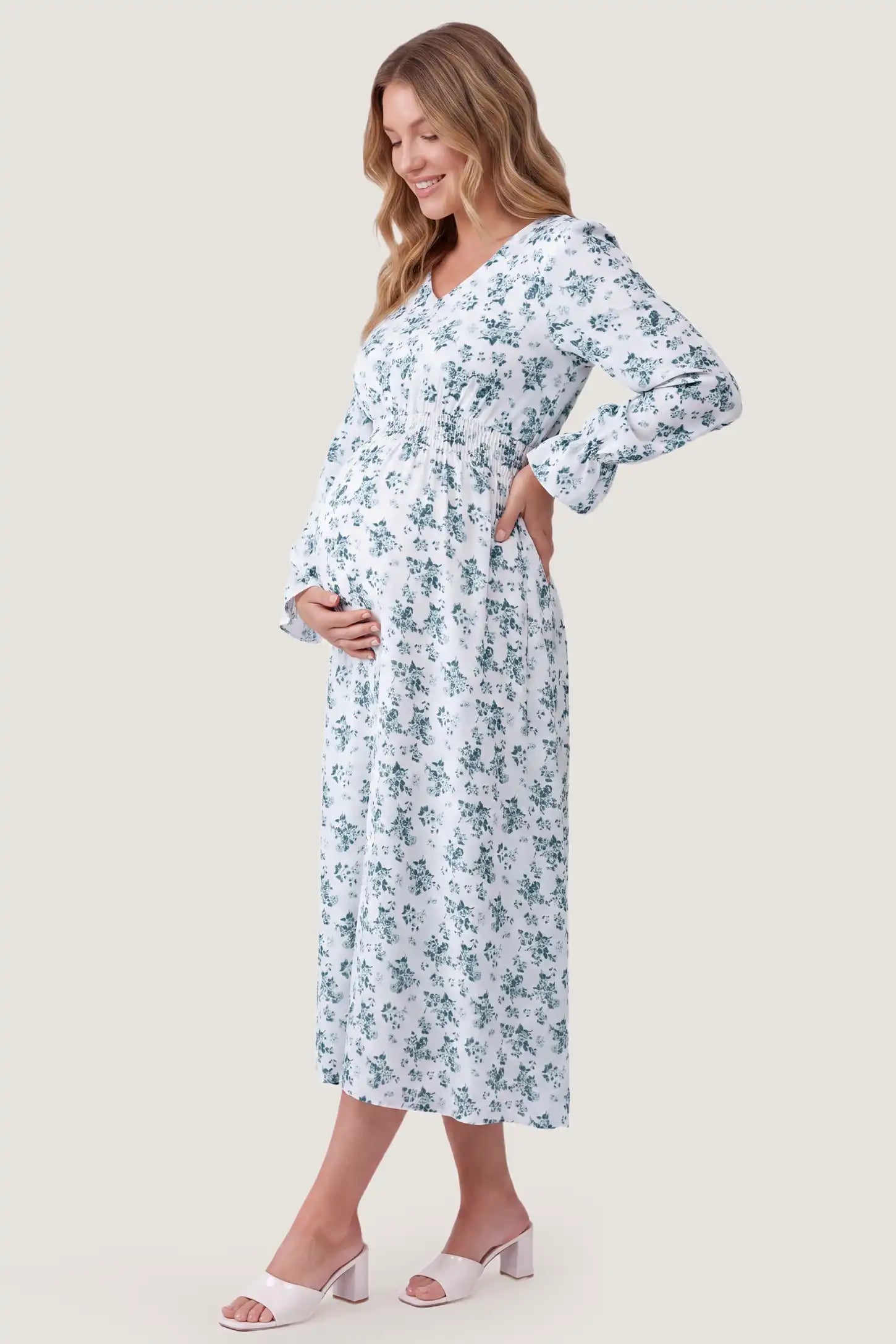 French Blue Floral V-Neck Maternity Dress French Blue Floral V-Neck Maternity Dress in French Blue Floral with an elastic waist, side view on a pregnant model.