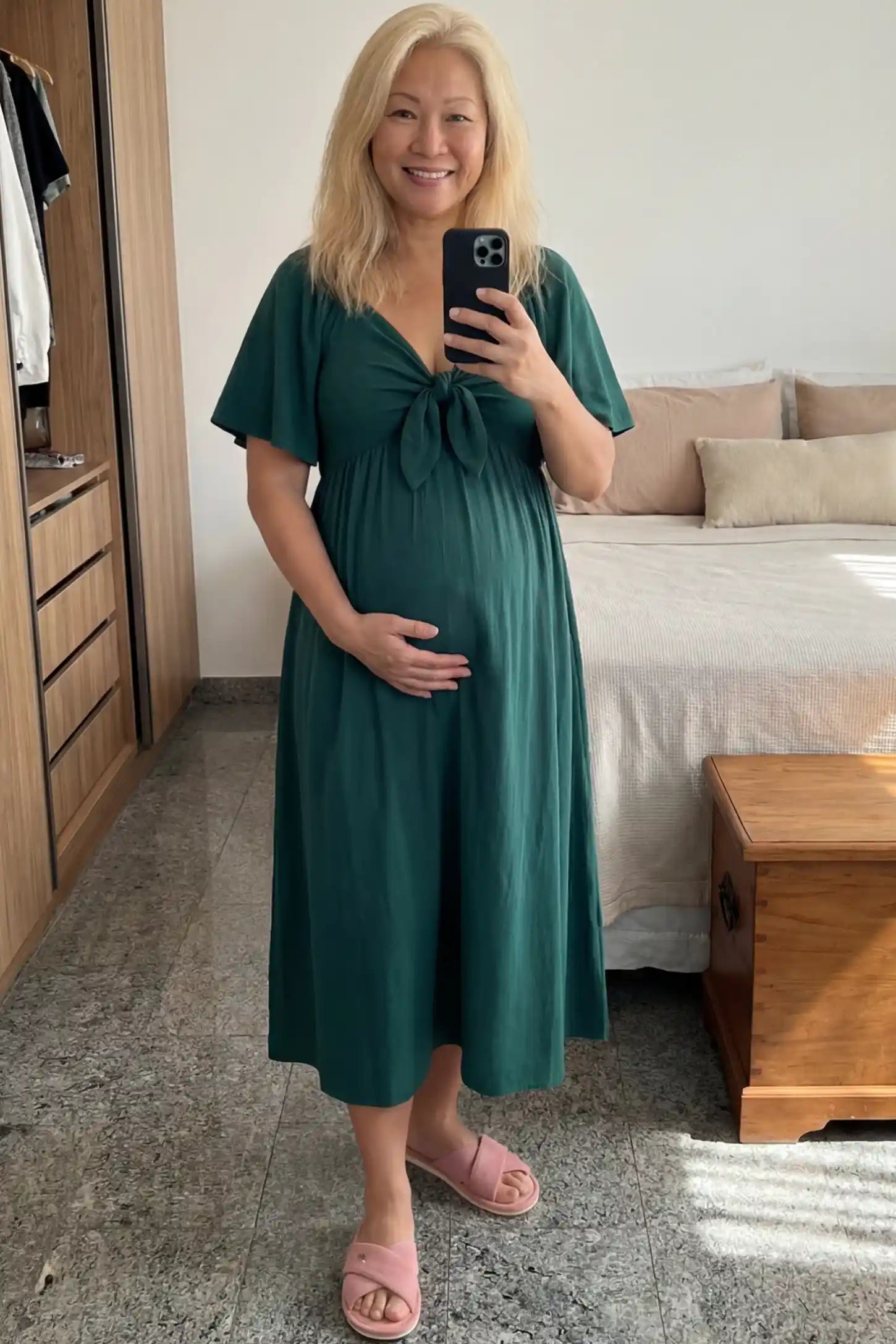 Front Tie Flutter Sleeve Maternity Midi Dress Front Tie Flutter Sleeve Maternity Midi Dress in Emerald Green featuring a knotted V-neckline and flowy skirt on a pregnant woman.