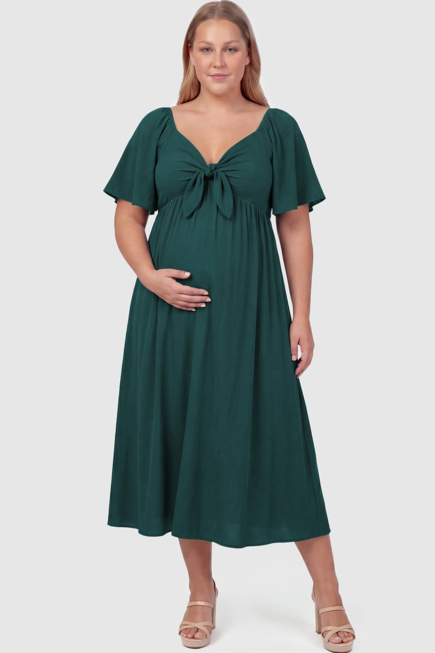Front Tie Flutter Sleeve Maternity Midi Dress Front Tie Flutter Sleeve Maternity Midi Dress in Emerald Green featuring a knotted V-neckline and flowy skirt on a plus size model.