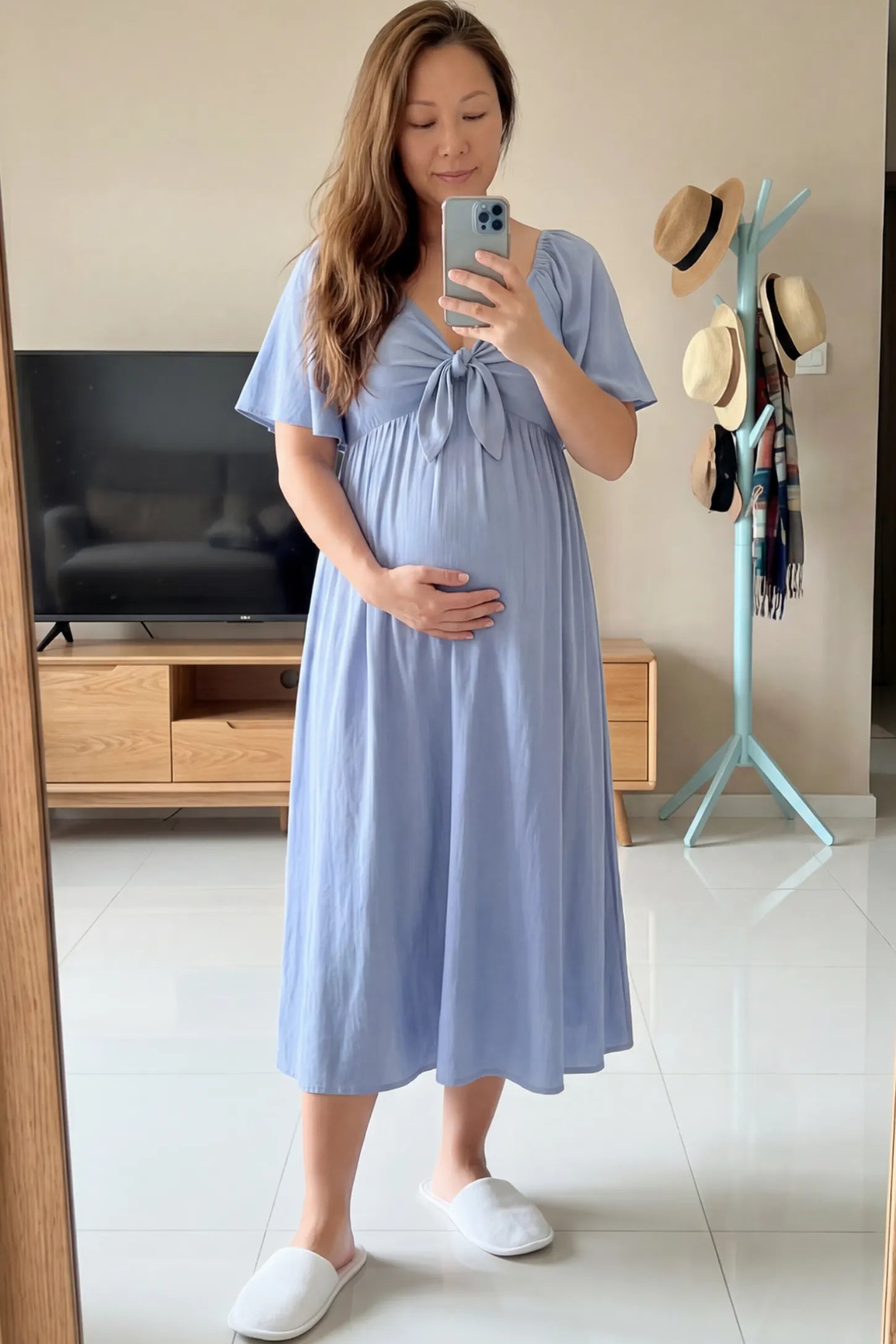 Front Tie Flutter Sleeve Maternity Midi Dress Front Tie Flutter Sleeve Maternity Midi Dress in Light Blue featuring a knotted V-neckline and flowy skirt on a pregnant woman.