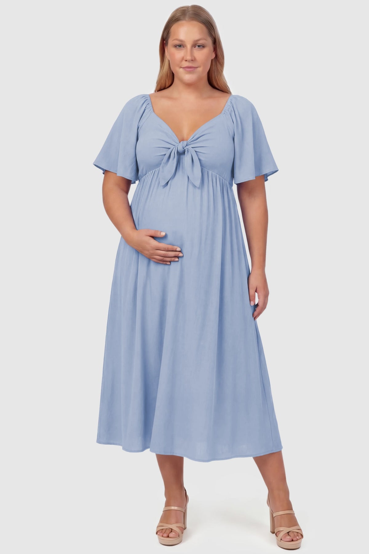 Front Tie Flutter Sleeve Maternity Midi Dress Front Tie Flutter Sleeve Maternity Midi Dress in light blue featuring a knotted V-neckline and flowy skirt on a plus size pregnant model, front view.