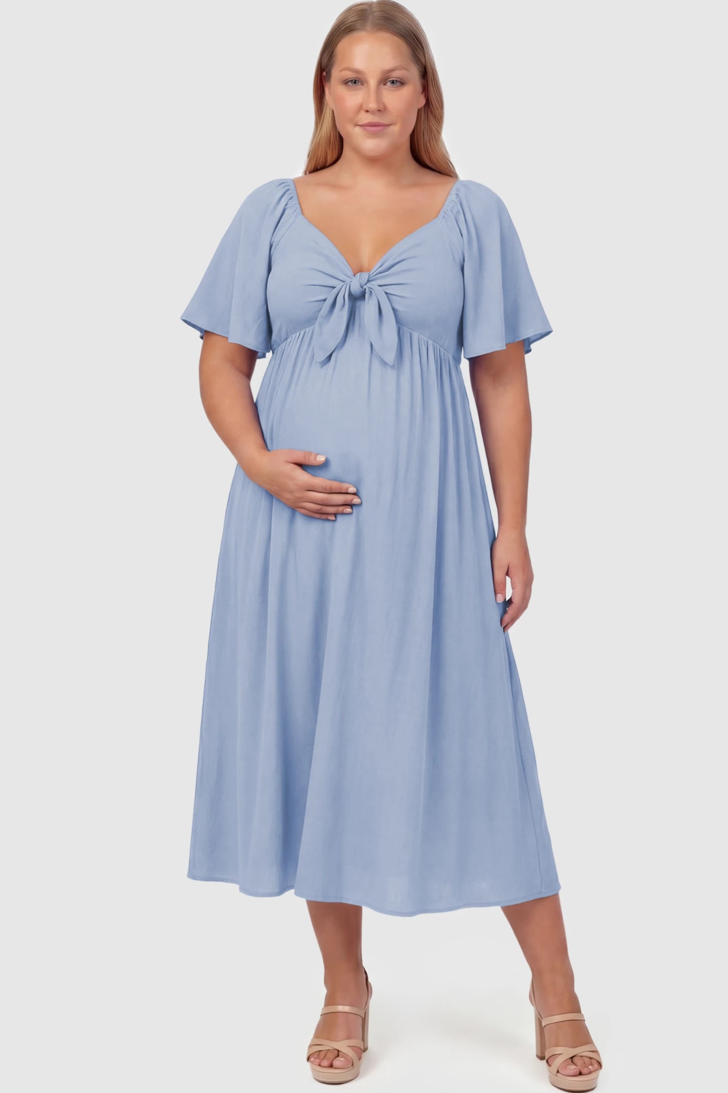 Front Tie Flutter Sleeve Maternity Midi Dress Front Tie Flutter Sleeve Maternity Midi Dress in Light Blue featuring a knotted V-neckline and flowy skirt on a plus size model.