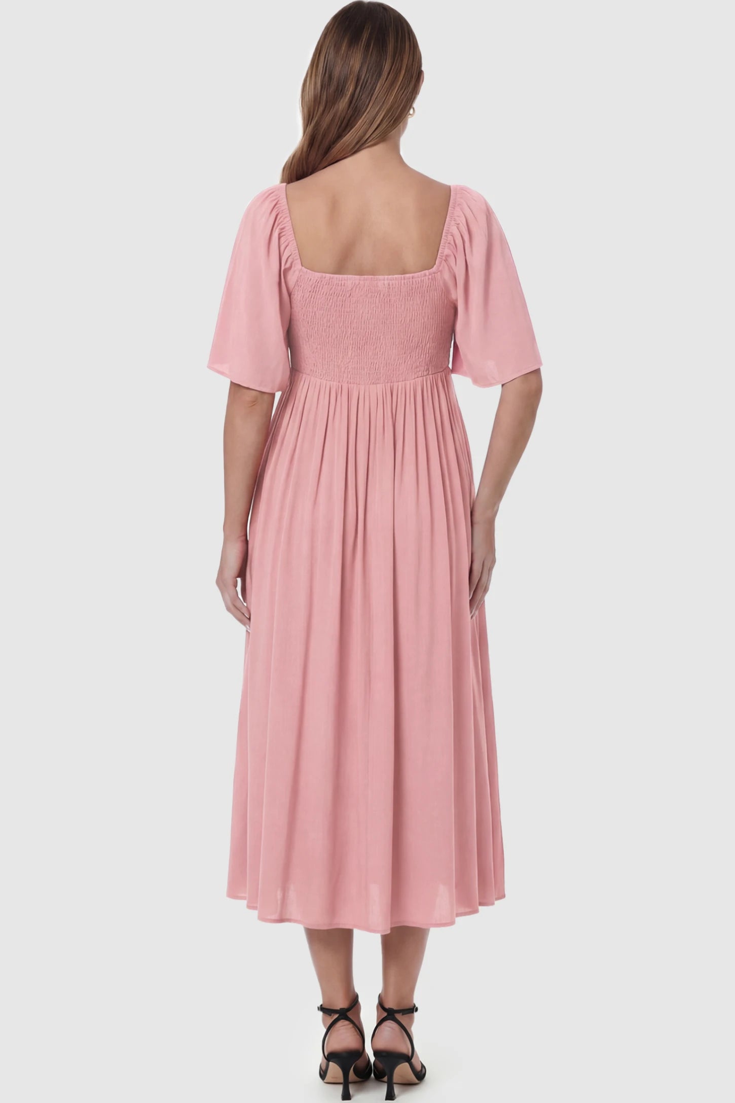 Front Tie Flutter Sleeve Maternity Midi Dress Front Tie Flutter Sleeve Maternity Midi Dress in pink featuring a knotted V-neckline and flowy skirt on a pregnant model showing back.